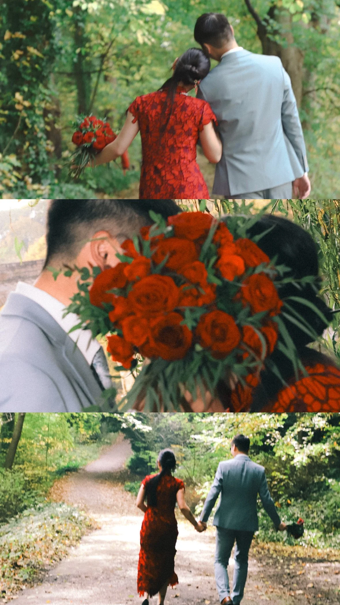 A couple walking hand in hand through a wooded area, with the woman in a red dress holding a bouquet of red roses, and the man in a light gray suit holding a single red rose.