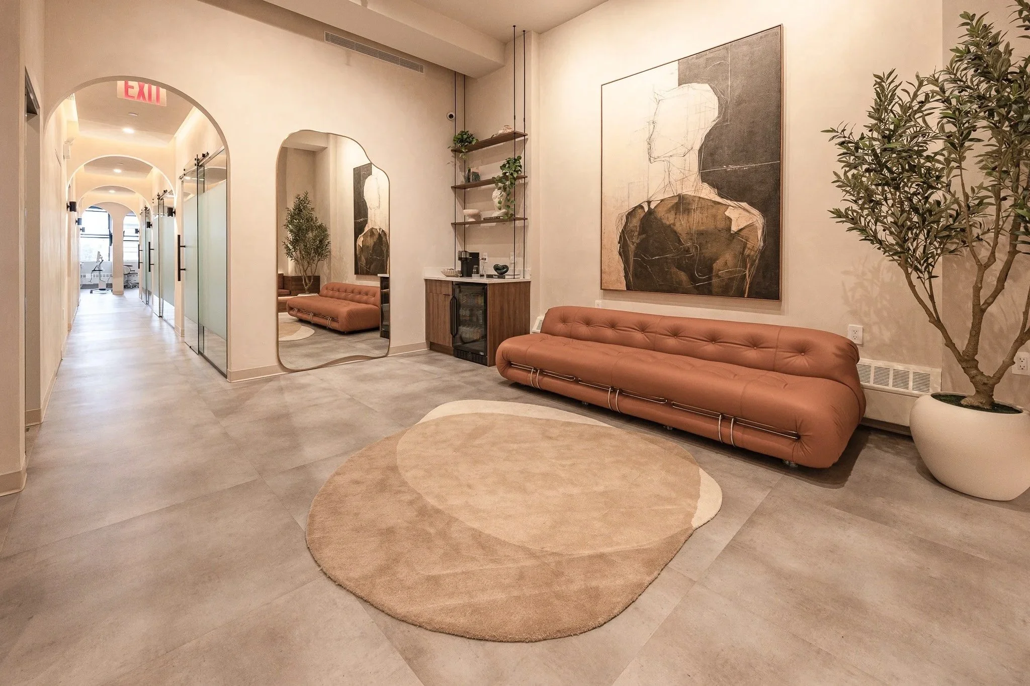 Modern reception area at Polish Dental in NoHo, New York City featuring warm wood finishes, custom millwork, soft lighting, and hospitality-inspired design.
