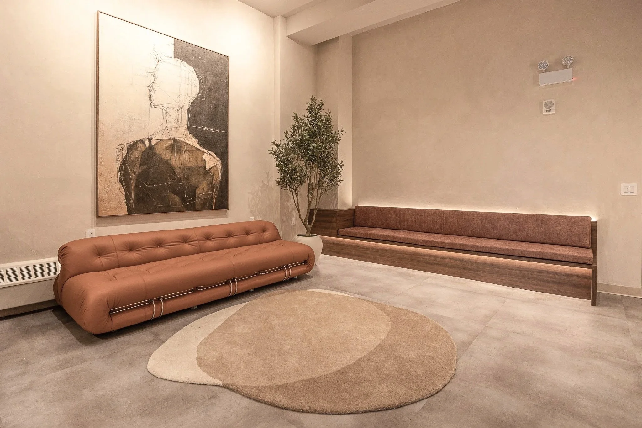 Modern reception area at Polish Dental in NoHo, New York City featuring warm wood finishes, custom millwork, soft lighting, and hospitality-inspired design.