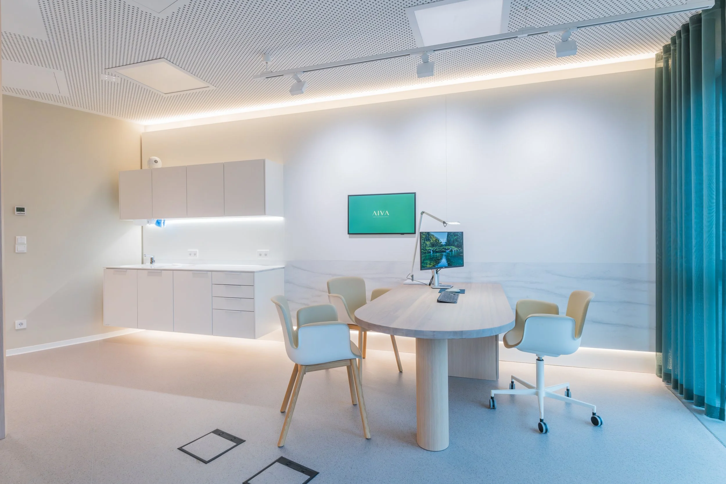 Modern minimalist office meeting room with oval table, chairs, dual monitors, built-in cabinets, and blue curtains