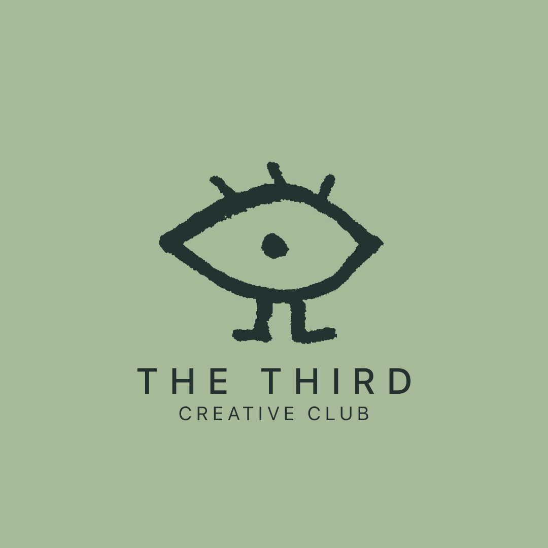 A simple, hand-drawn illustration of an eye with two eyelashes on top, two legs, and a dot inside the eye, set against a light green background. Below the illustration, it reads "THE THIRD CREATIVE CLUB."