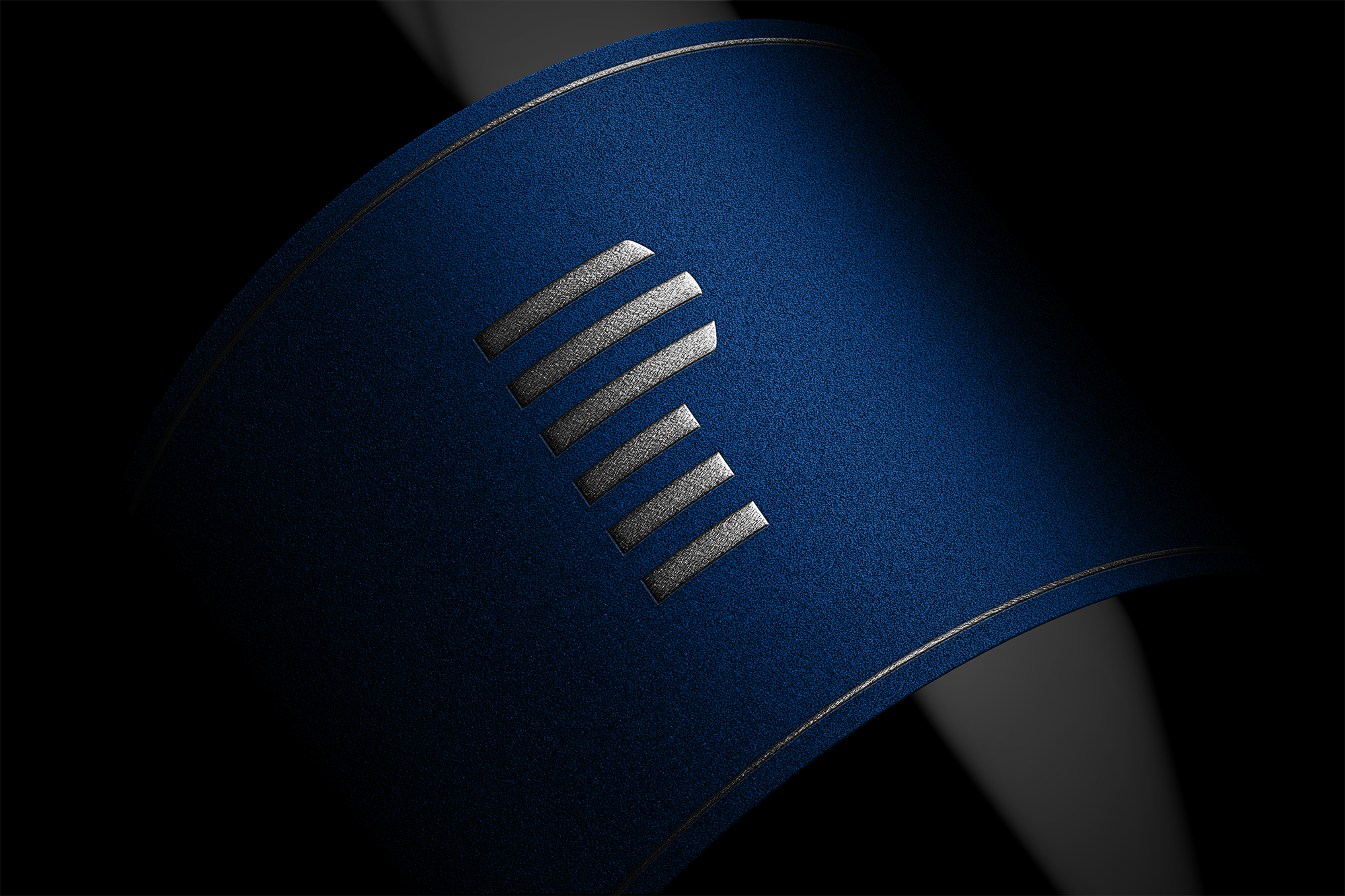 Close-up of a blue cylindrical object with silver vents or slots on its surface, set against a dark background.