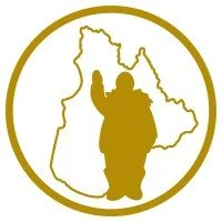 Silhouette of a person carrying a child, set against the outline of a map of Guatemala, all within a gold circle.