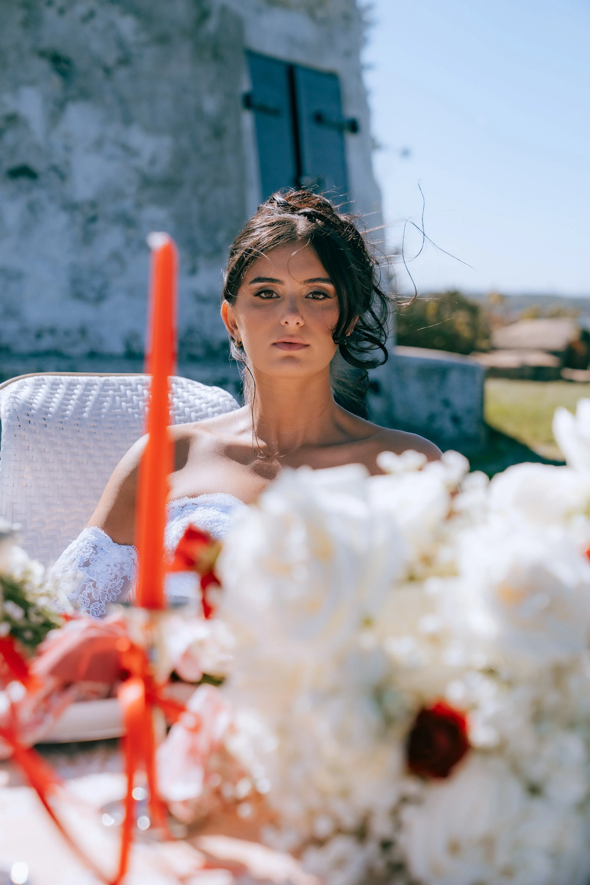 Romantic proposal picnic with champagne, florals, and ocean view backdrop