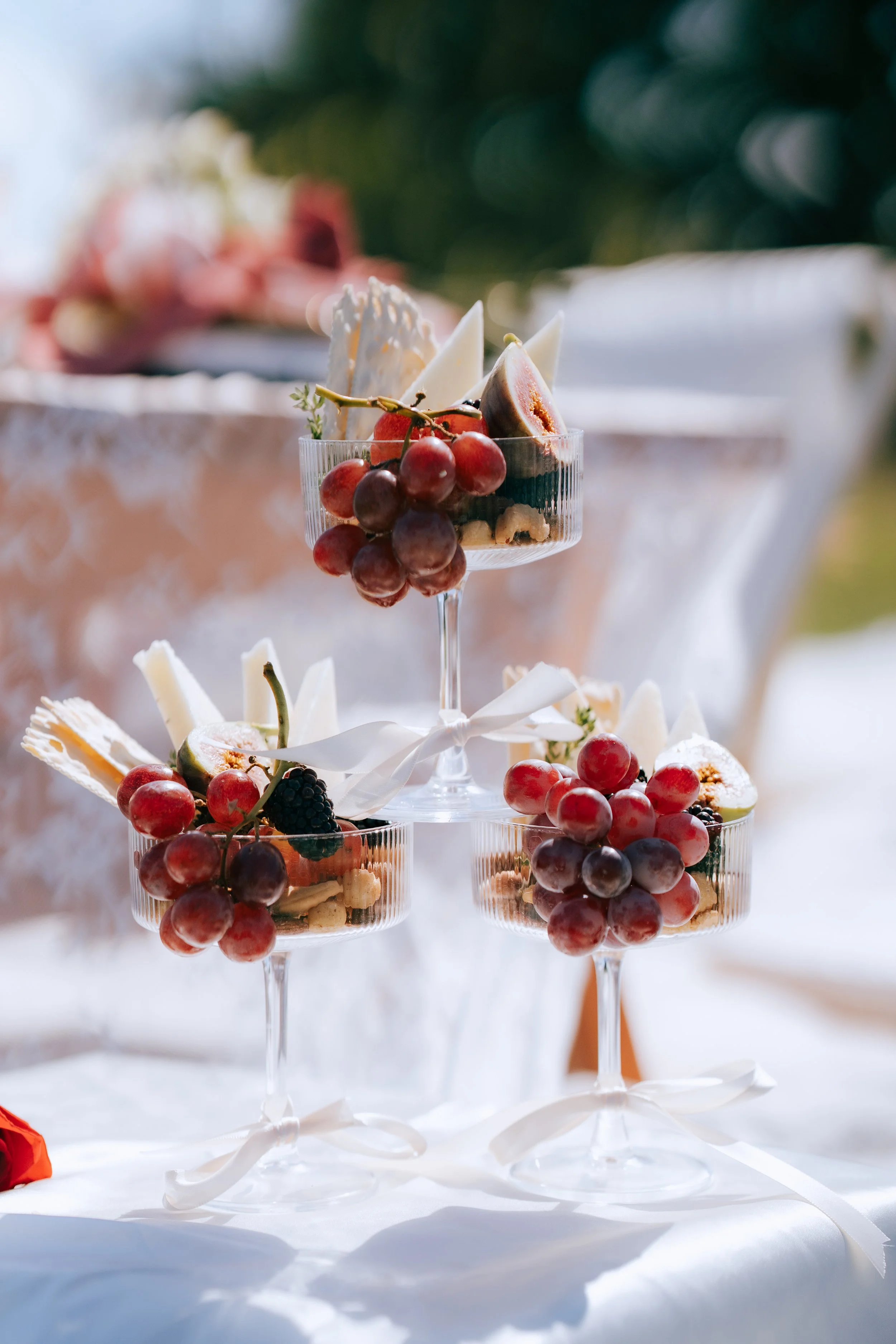 Romantic proposal picnic with champagne, florals, and ocean view backdrop