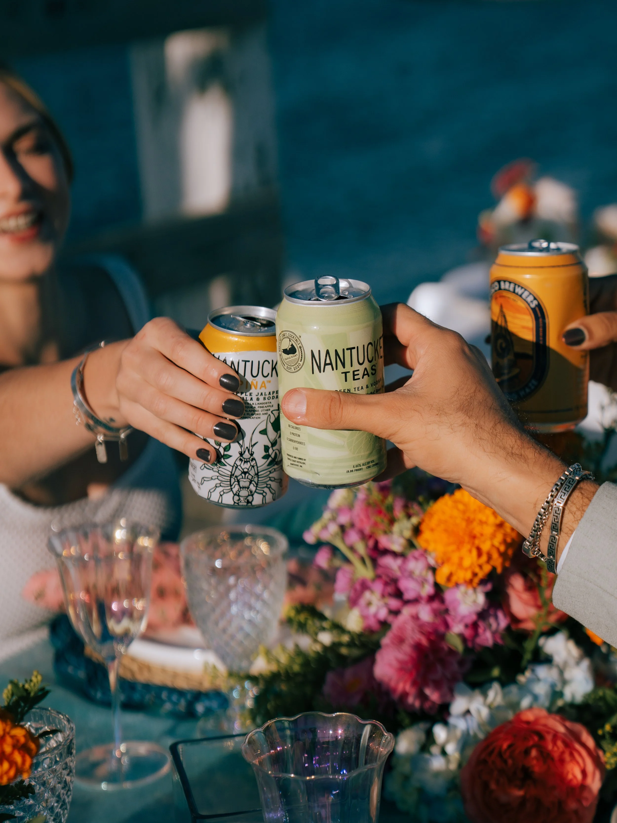 Luxury beach picnic setup with low tables, layered rugs, and coastal décor styling featuring Cisco Brewers