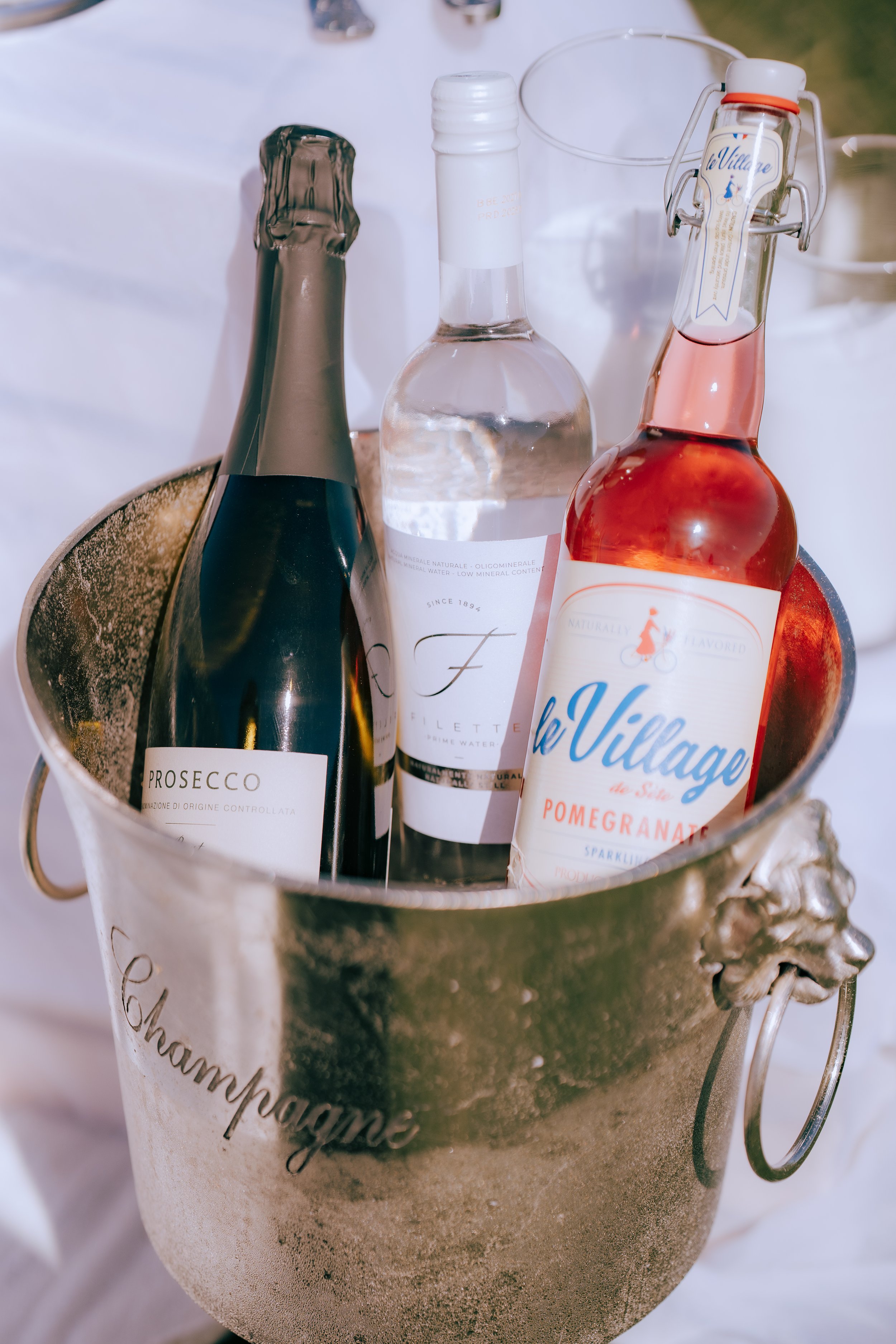 Romantic proposal picnic with champagne, florals, and ocean view backdrop