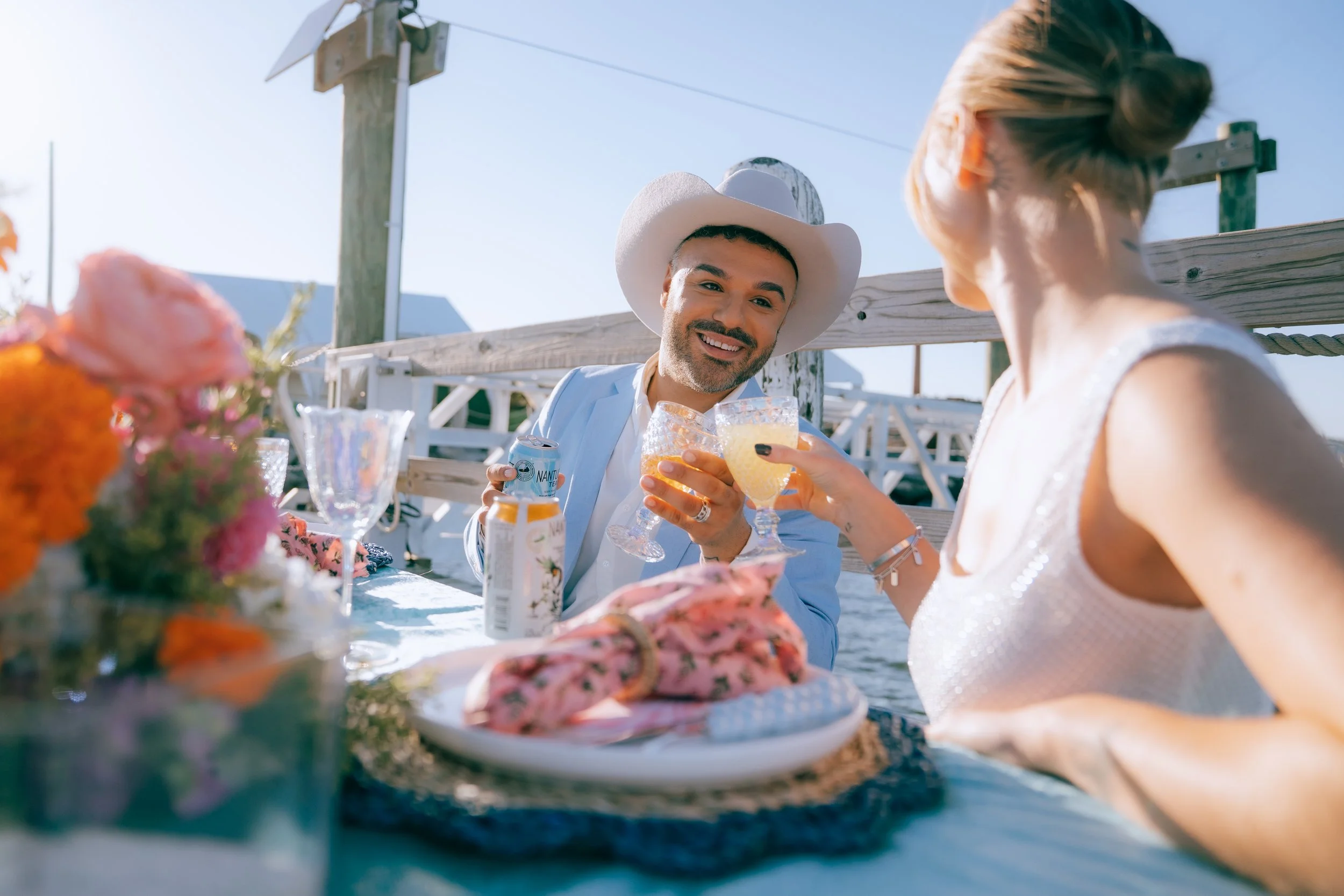 Luxury beach picnic setup with low tables, layered rugs, and coastal décor styling
