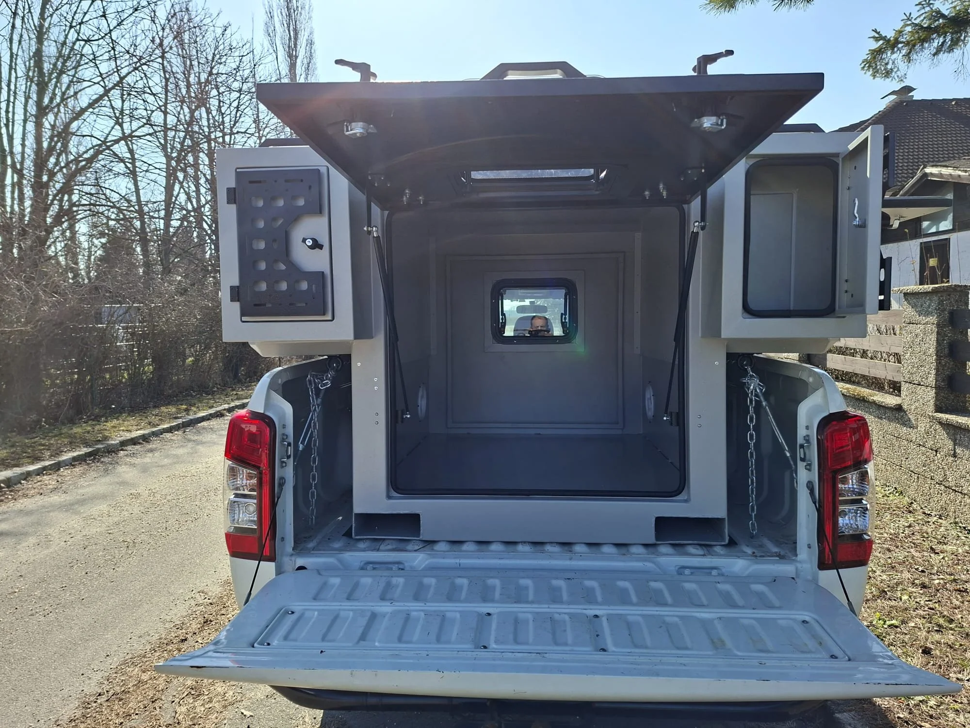 Demountable DEBOXS universal pickup storage system. Featuring integrated roof bars for roof cargo such as ladders, or rooftop tents, this rugged adventure and work canopy replacement offers a non-invasive mounting system that protects vehicle lease r