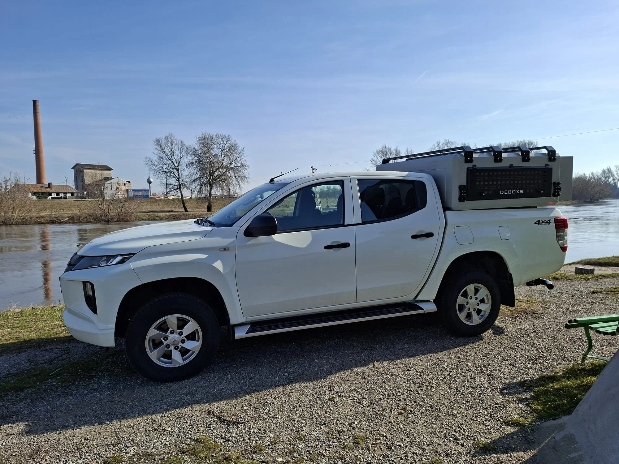 Demountable DEBOXS universal pickup storage system. Featuring integrated roof bars for roof cargo such as ladders, or rooftop tents, this rugged adventure and work canopy replacement offers a non-invasive mounting system that protects vehicle lease r