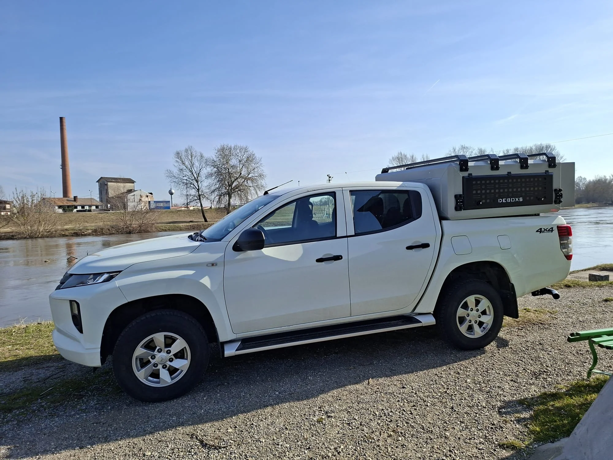Demountable DEBOXS universal pickup storage system. Featuring integrated roof bars for roof cargo such as ladders, or rooftop tents, this rugged adventure and work canopy replacement offers a non-invasive mounting system that protects vehicle lease r