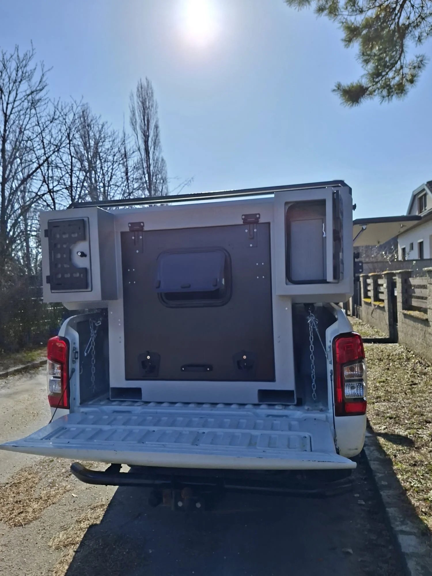 Demountable DEBOXS universal pickup storage system. Featuring integrated roof bars for roof cargo such as ladders, or rooftop tents, this rugged adventure and work canopy replacement offers a non-invasive mounting system that protects vehicle lease r