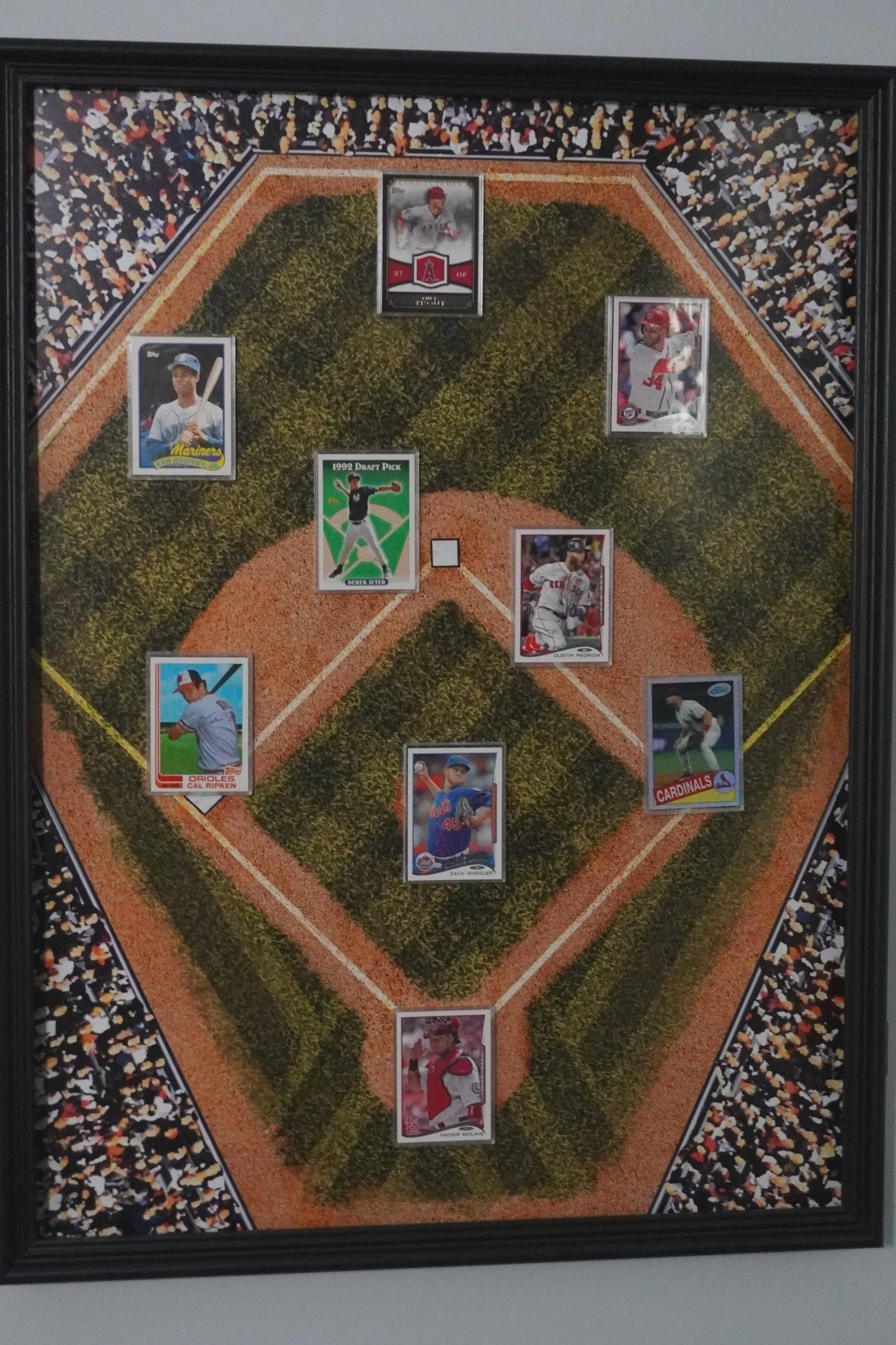 Framed baseball card collection arranged on a baseball field diagram background.
