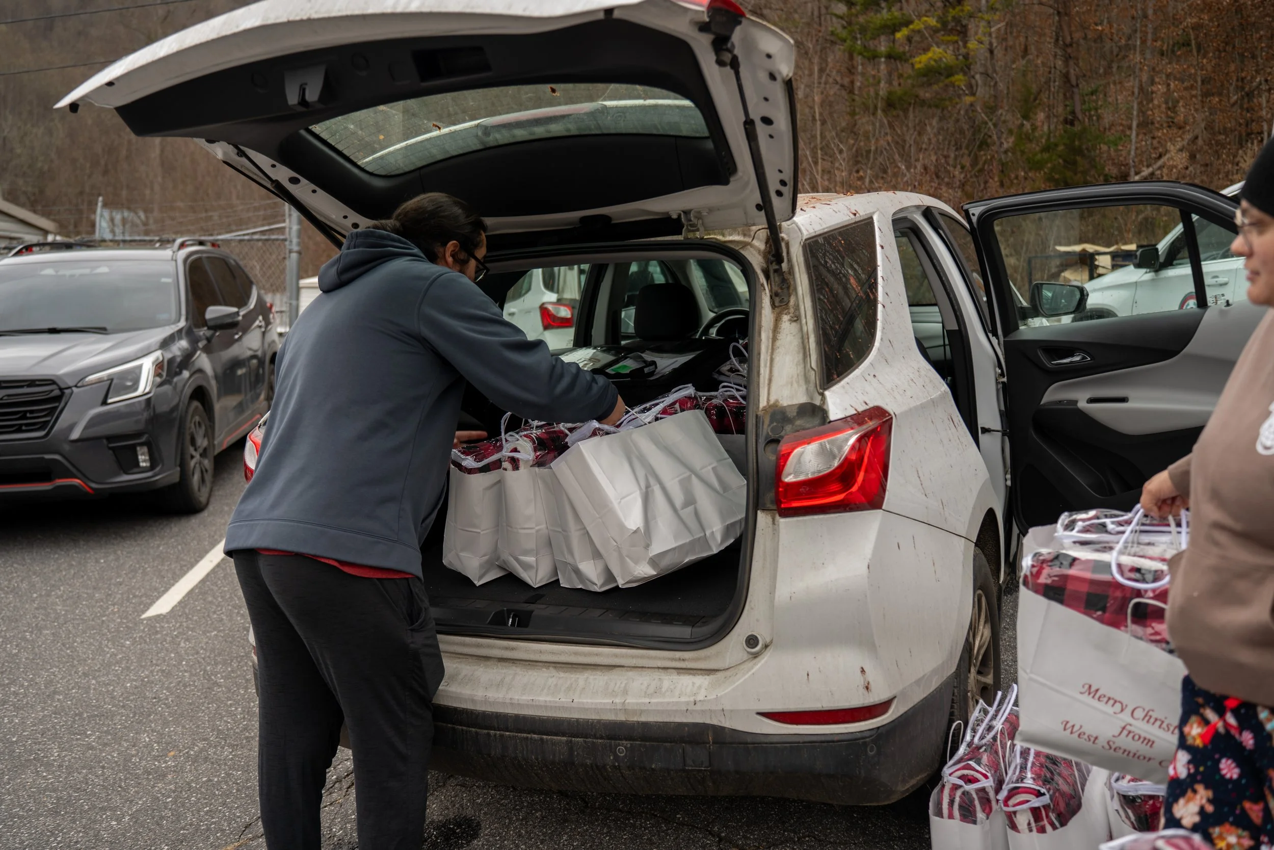 someone loading gift bags into a car