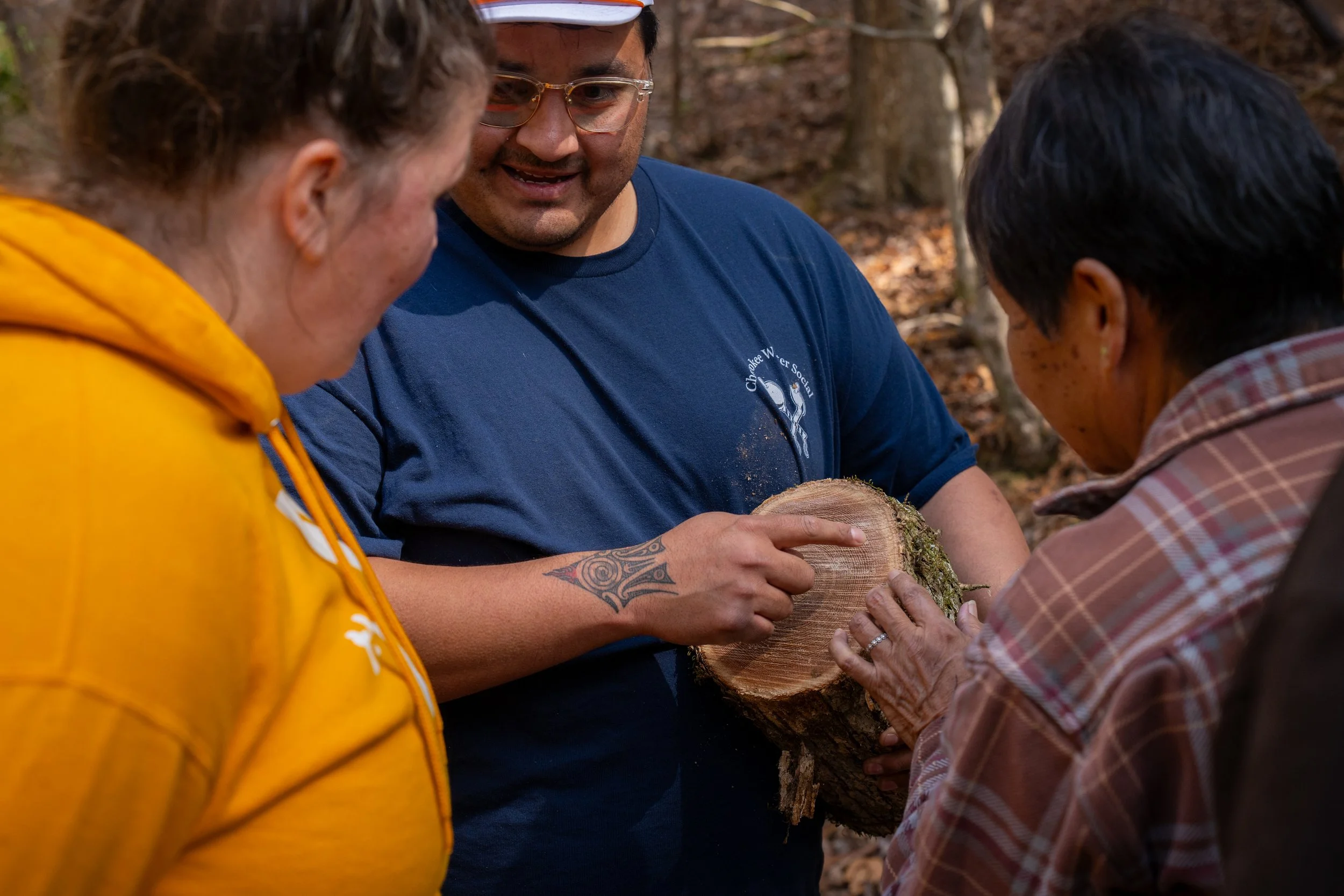 three people, one holding a piece of white oak