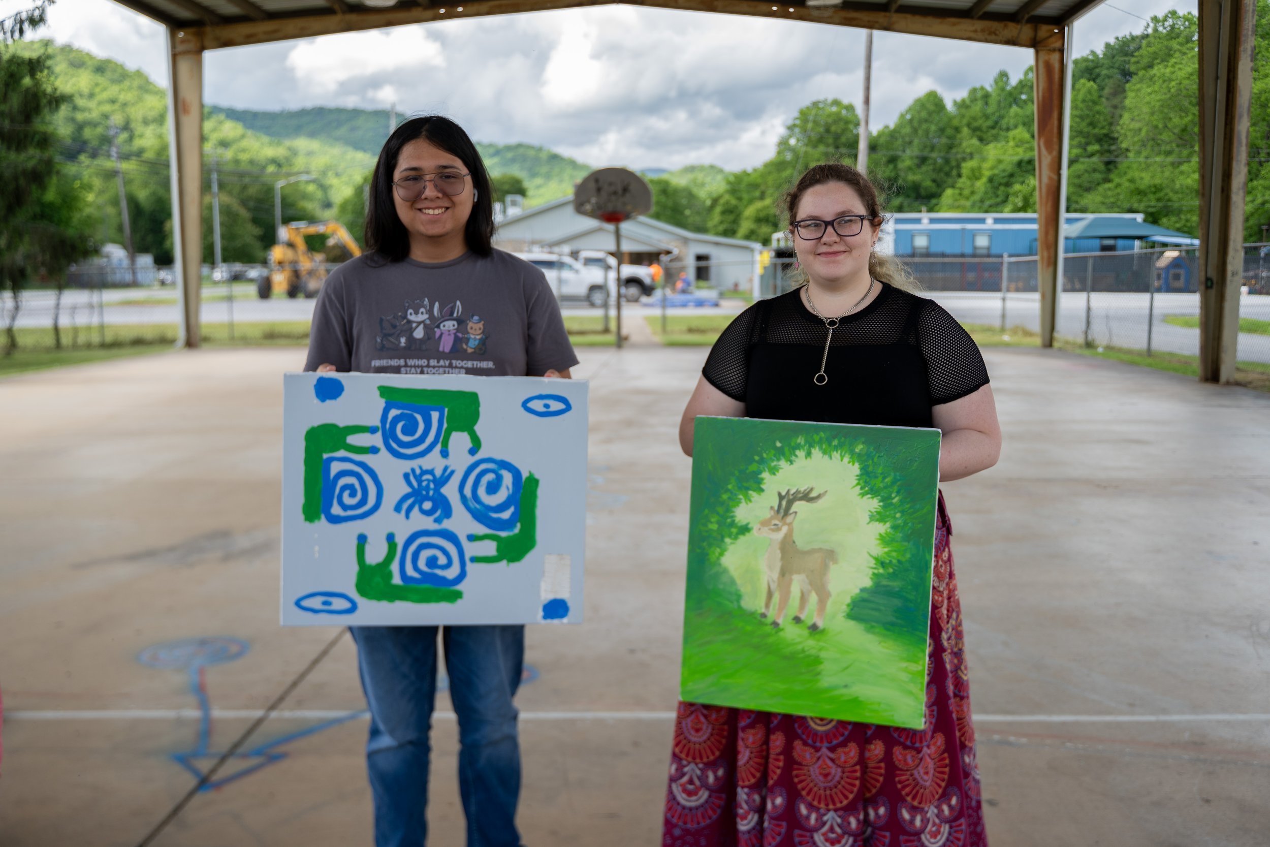 members of youth conservation club holding the bee box lids that they painted