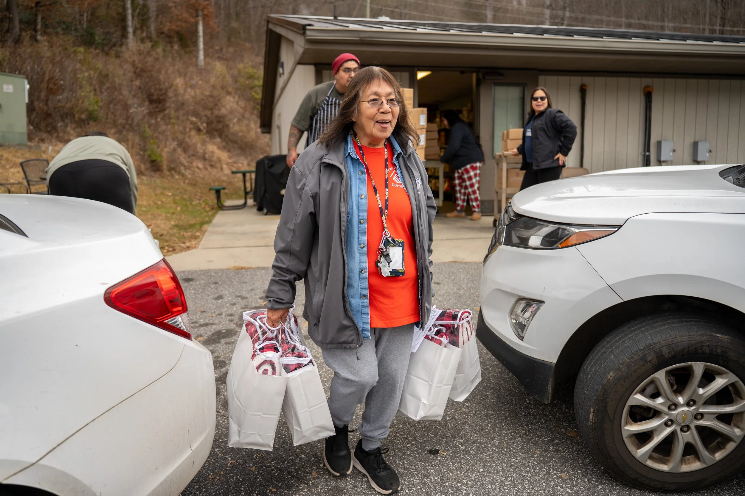 elder taking gift bags to cars