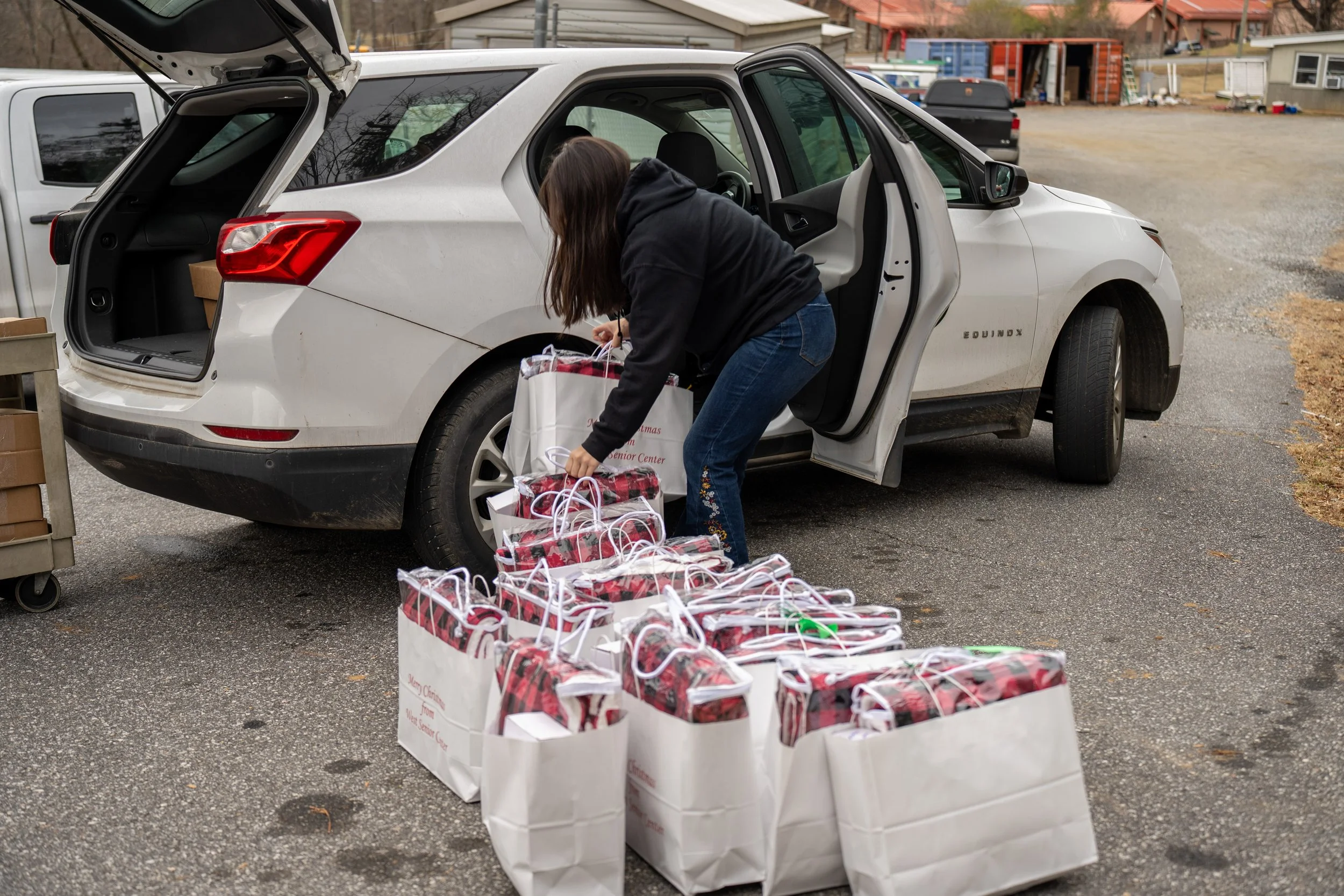 someone loading gift bags into a car