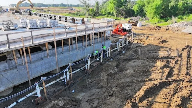 Wellpoint dewatering header and risers installed along a bridge abutment excavation