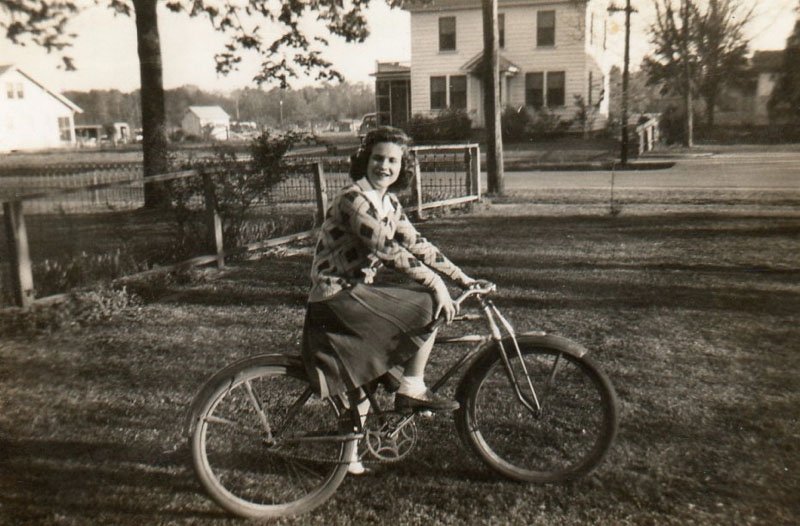 copy_0_edith-chapman-on-bike-with-christopher-house-in-background