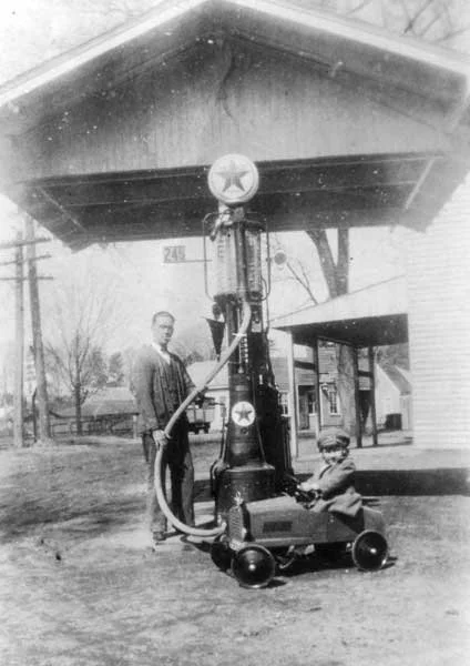  Charlie Johnson with daughter Mary Virginia in front of Johnson’s Store in Chuckatuck - 1925  Notice F.A. Spady Store and Garage in the background.  Johnson Family photo 