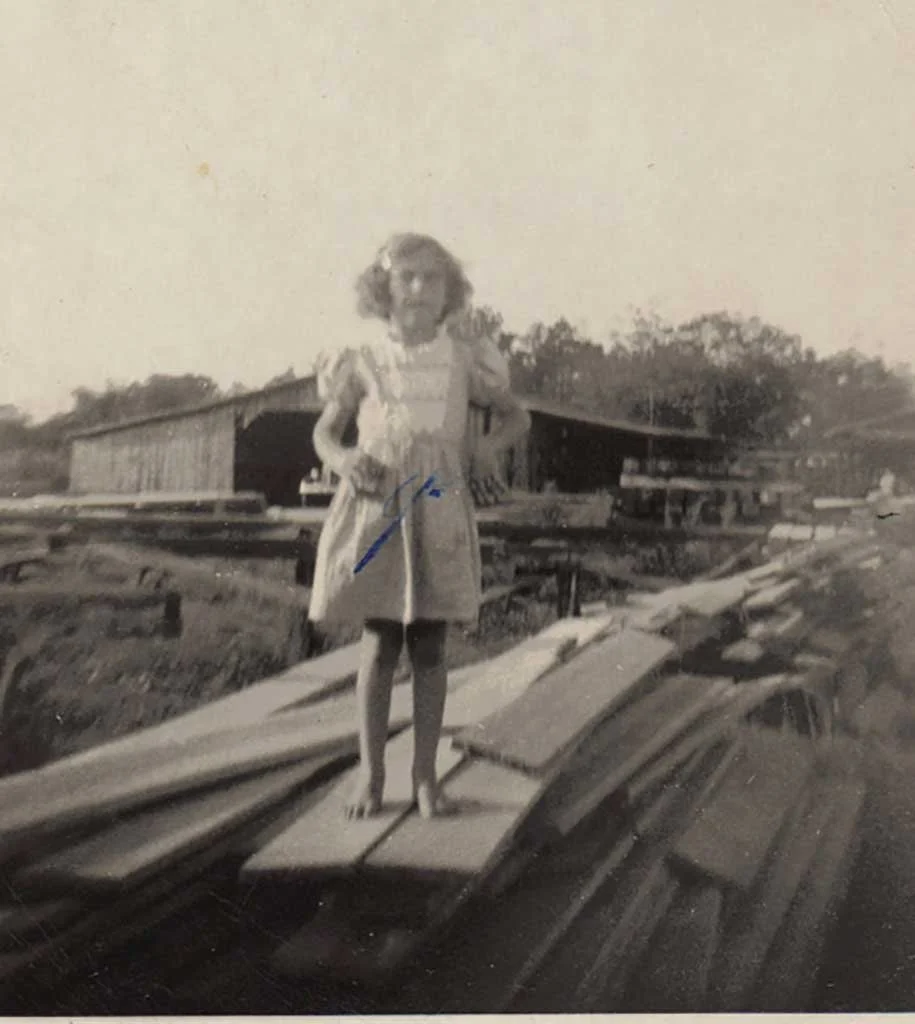 Janet Knight on Saunders Supply Co. wood pile located behind her home on Godwin Blvd.  Knight Family photo 