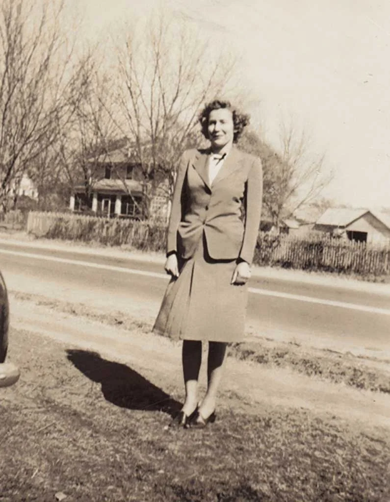  Irene Pinner Knight with the home of Dr. L. L. Eley in the background. Irene was the secretary of Saunders Supply Co. for many years.  Kelly Family photo 