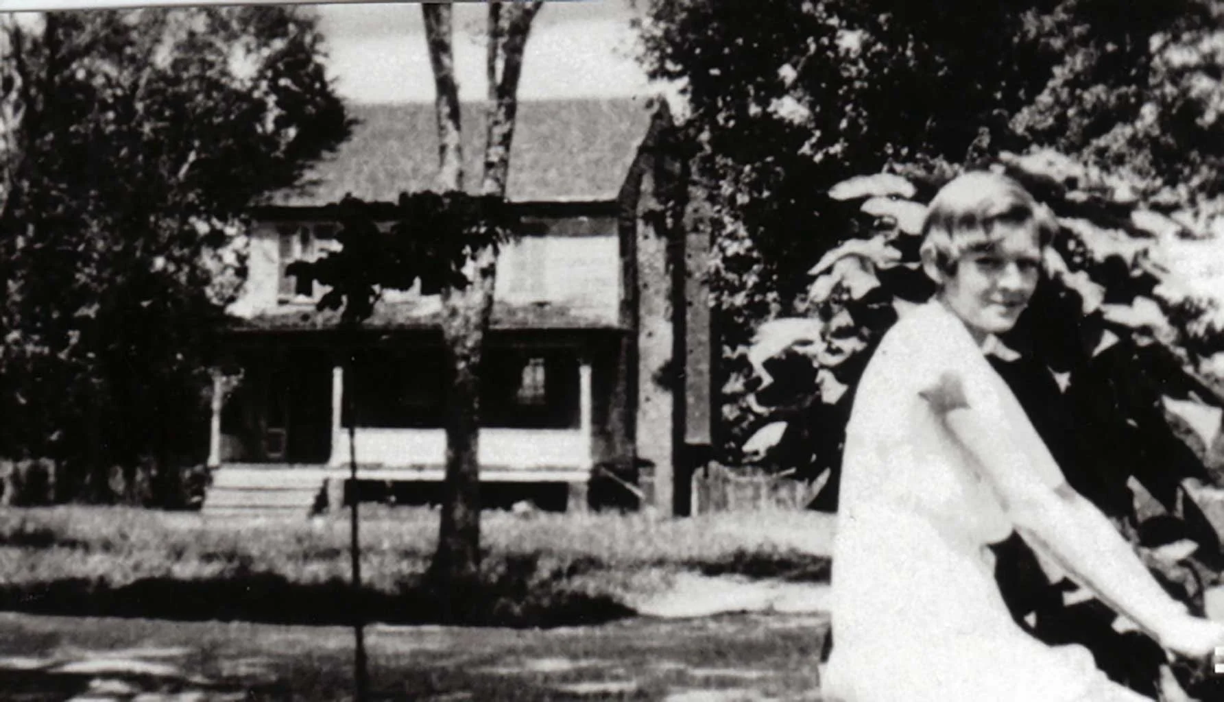  Matsie Moore with E.C. Ramsey's home in the background. c1932. Ramsey's home was located behind what is now Kitty’s Beauty Salon.   