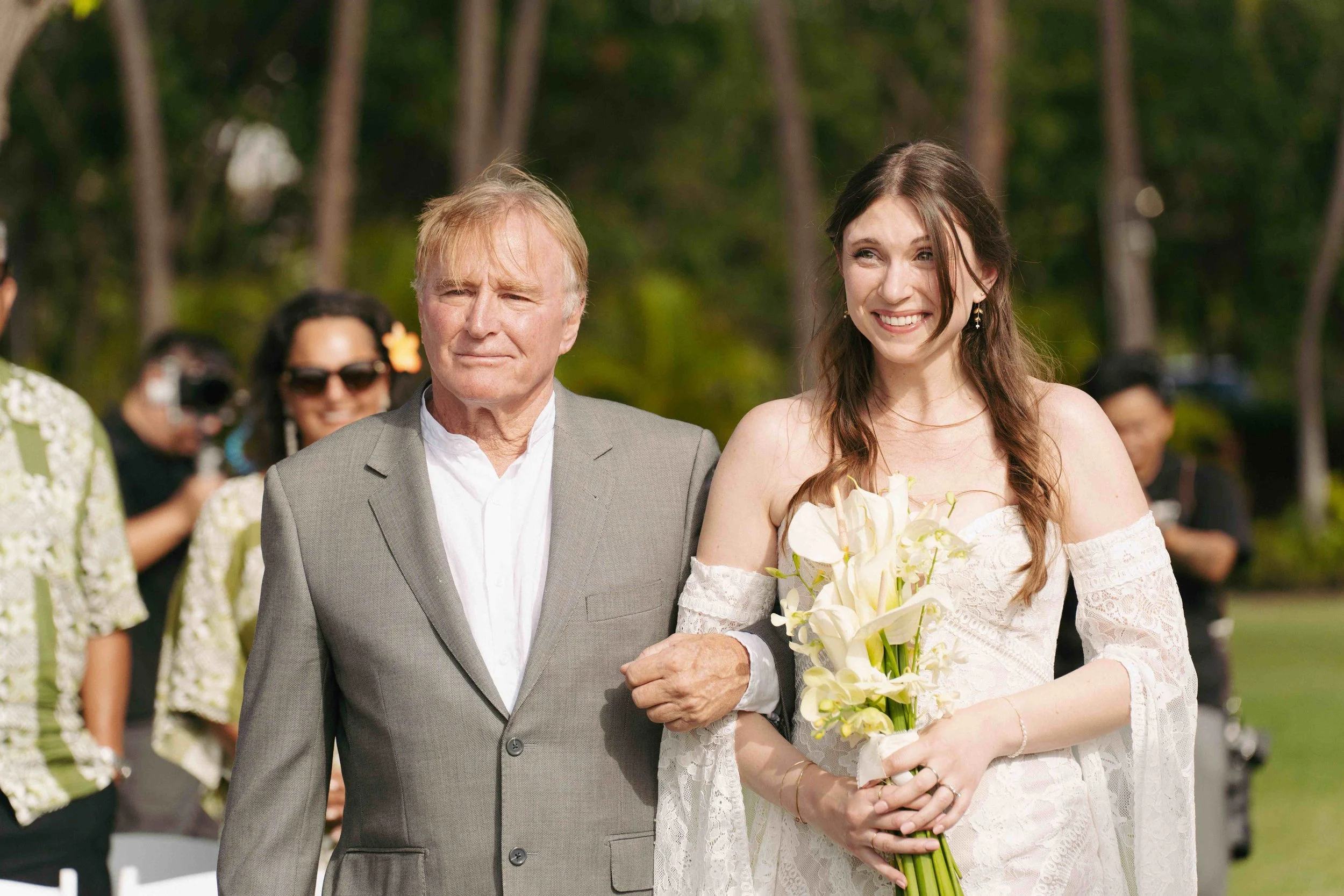 father of the bride and the bride walking down the ailse at Lanikuhonua Ko Olina Oahu Hawaii.