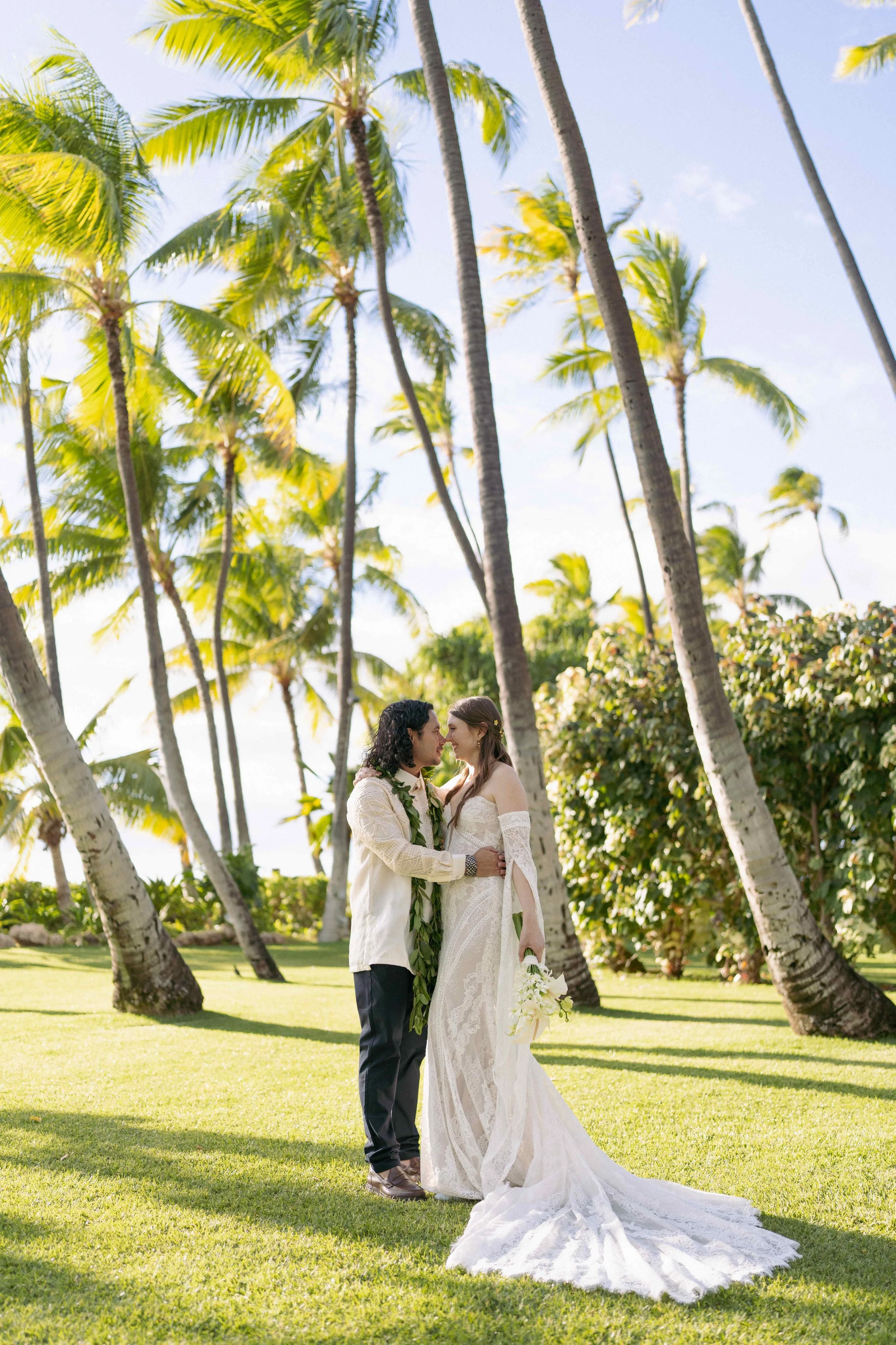 Bride and groom kissing outdoors at Lanikuhonua Ko Olina Oahu Hawaii.