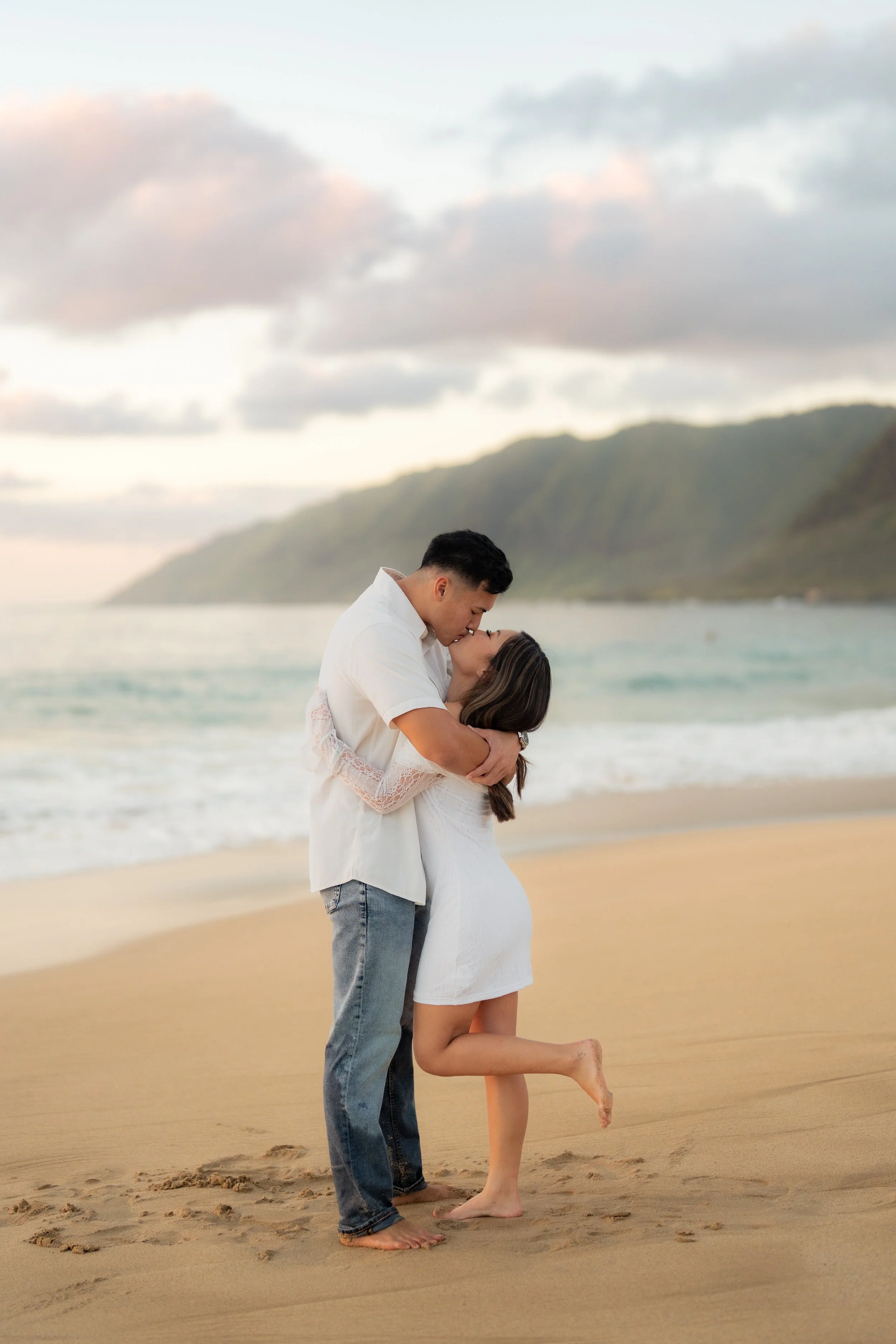 Bride and groom in wedding attire touching foreheads outdoors hawaii taken by aloha media weddings