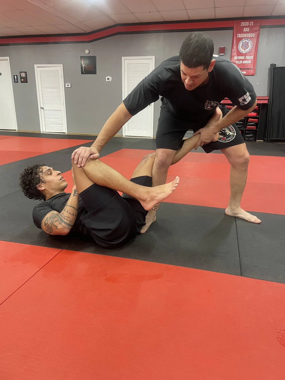 Advanced Brazilian Jiu-Jitsu students drilling a leg lock at Legacy Martial Arts Silver Spring MD
