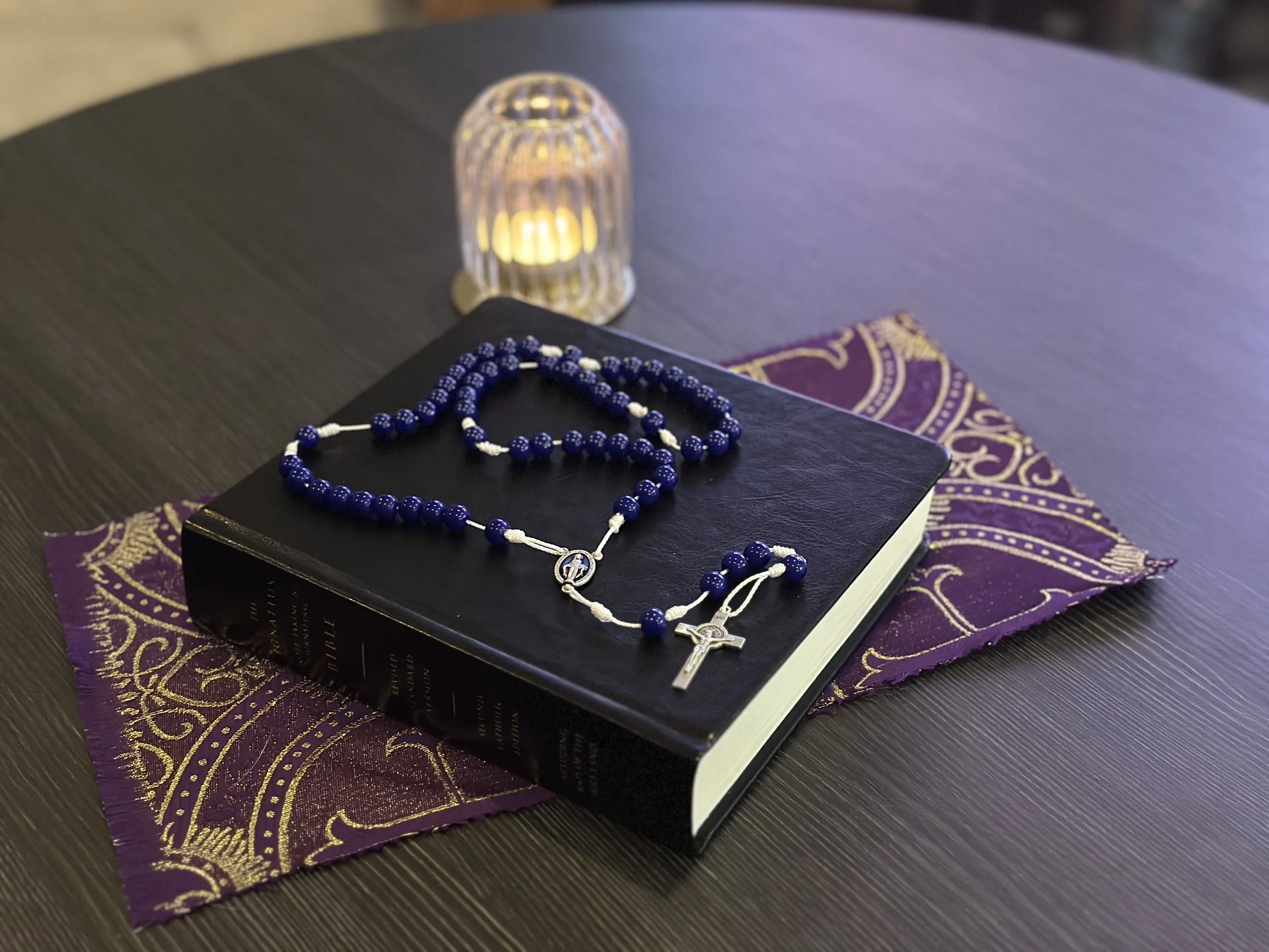 The Restorative Waters Rosary with blue glass beads and a white cord for peaceful prayer and somatic restoration.