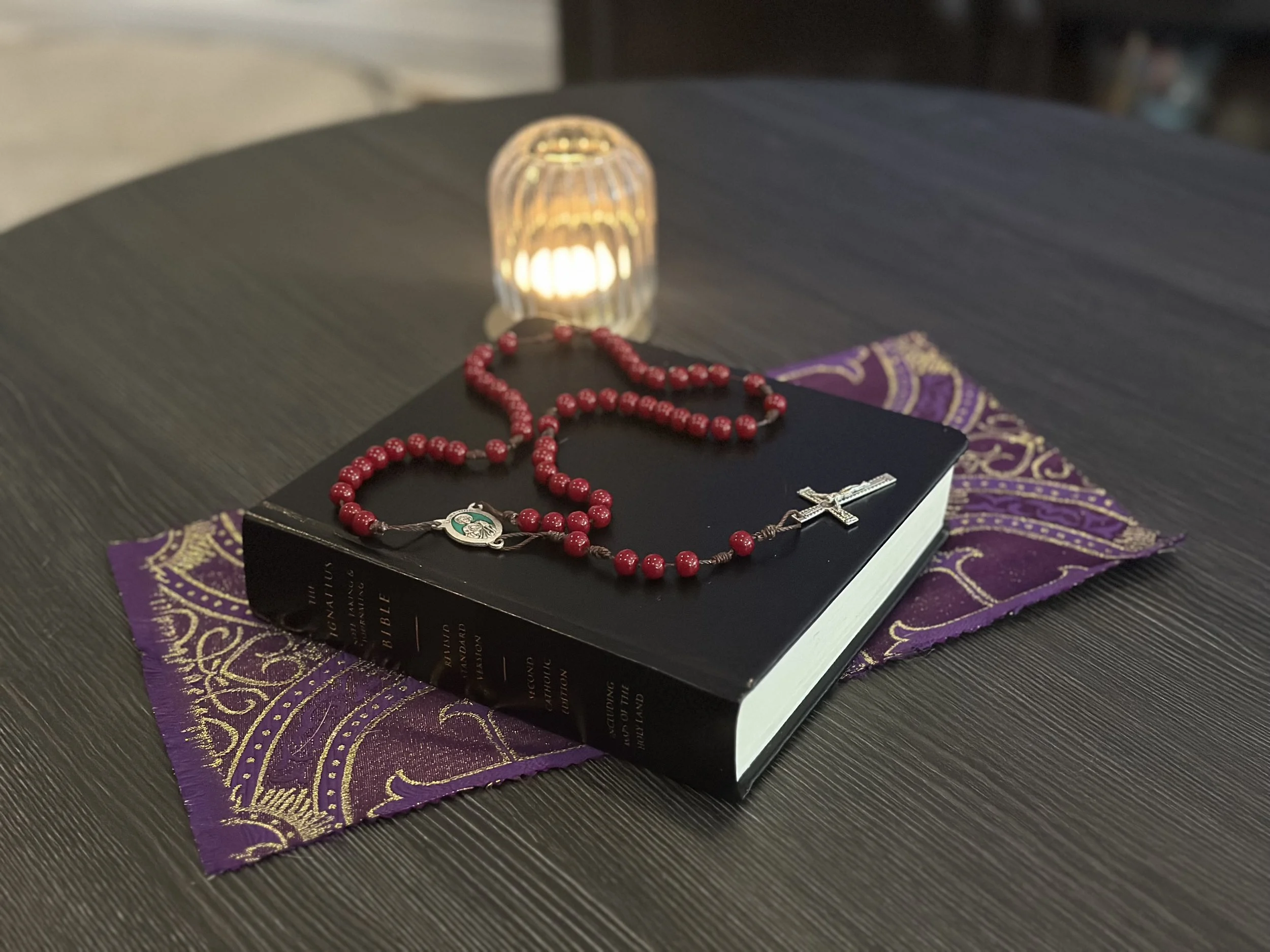 Handmade Sacred Heart Rosary with vibrant red glass beads on a sturdy brown cord.