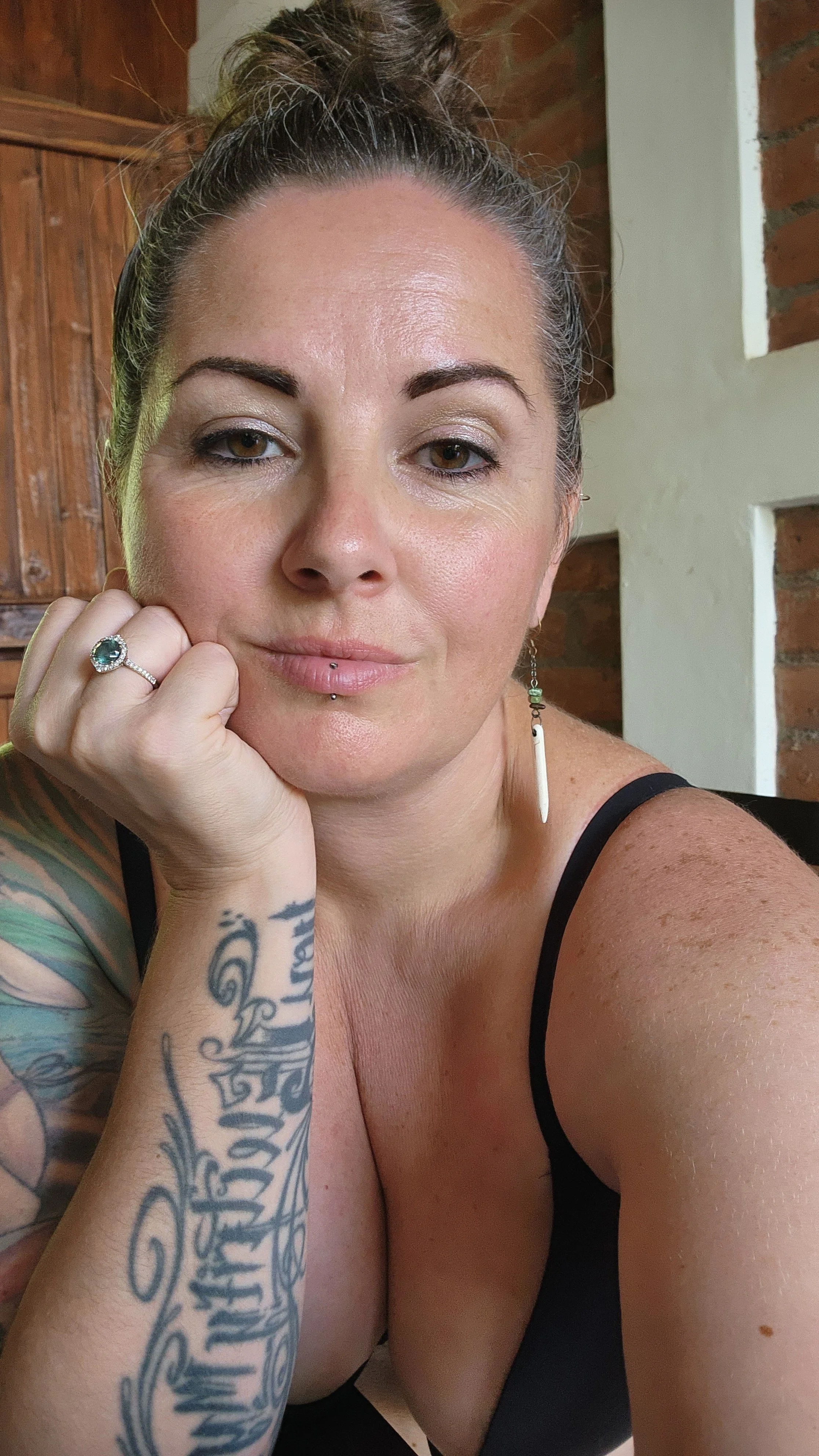 Tamara Doering, Calgary-based integrative pelvic health practitioner, resting her head on her hand in a calm, welcoming portrait representing women’s pelvic and womb care