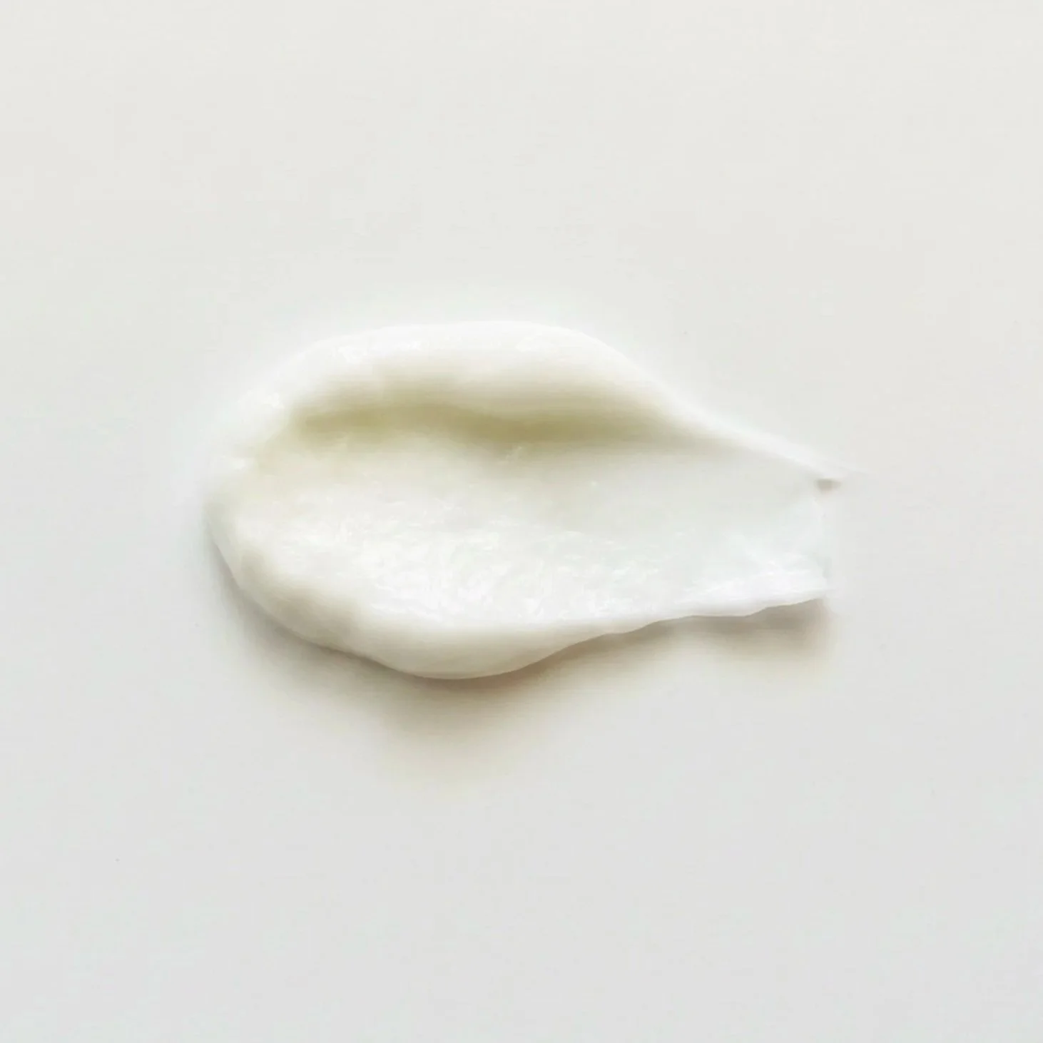 A swipe of white lotion against a white background, showing the smooth texture of the Halik Island Body Lotion