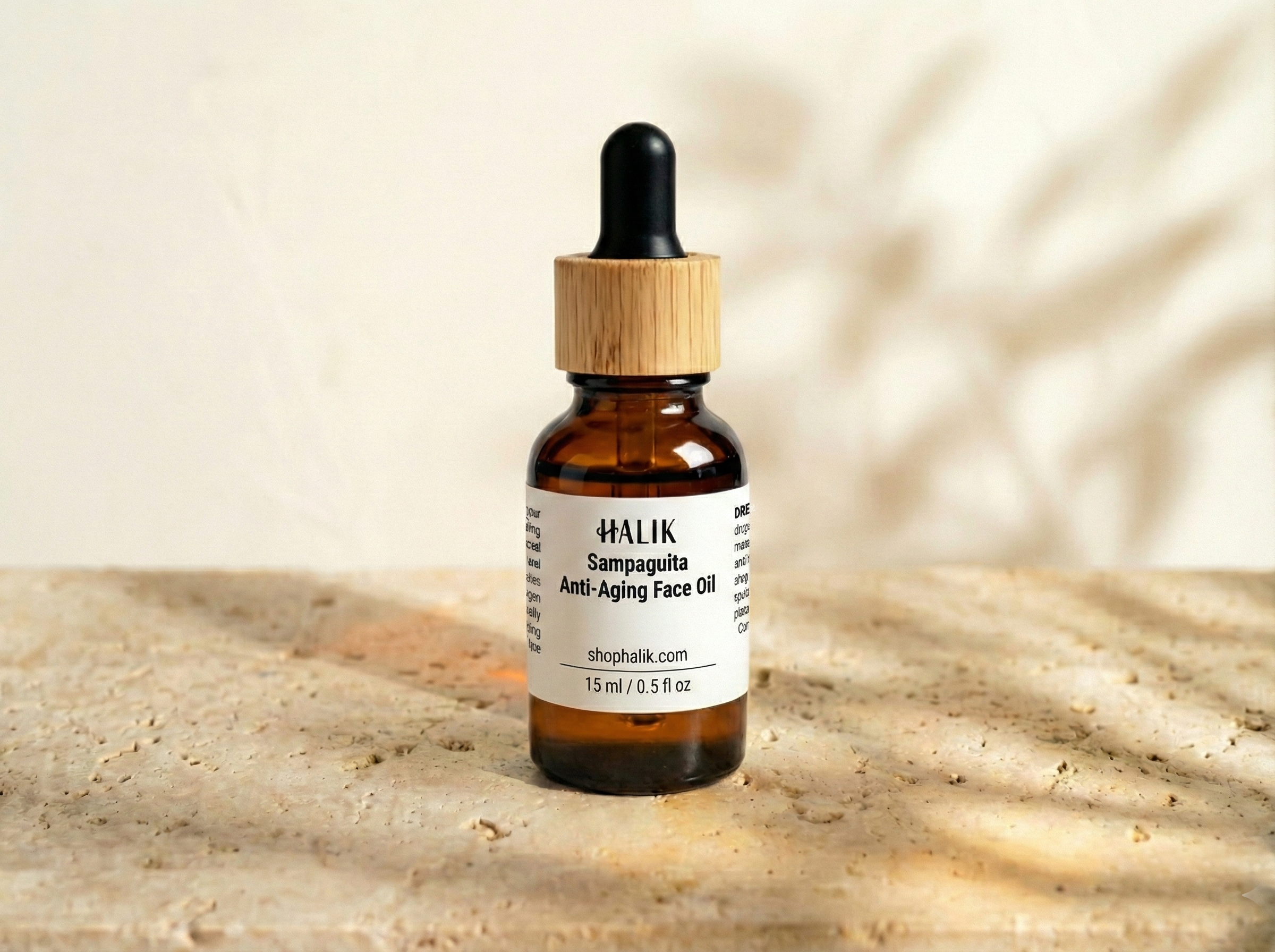 A small amber glass bottle with a wooden cap and black dropper, labeled 'HALIK Sampaguita Anti-Aging Face Oil' on a light textured surface with a neutral background.