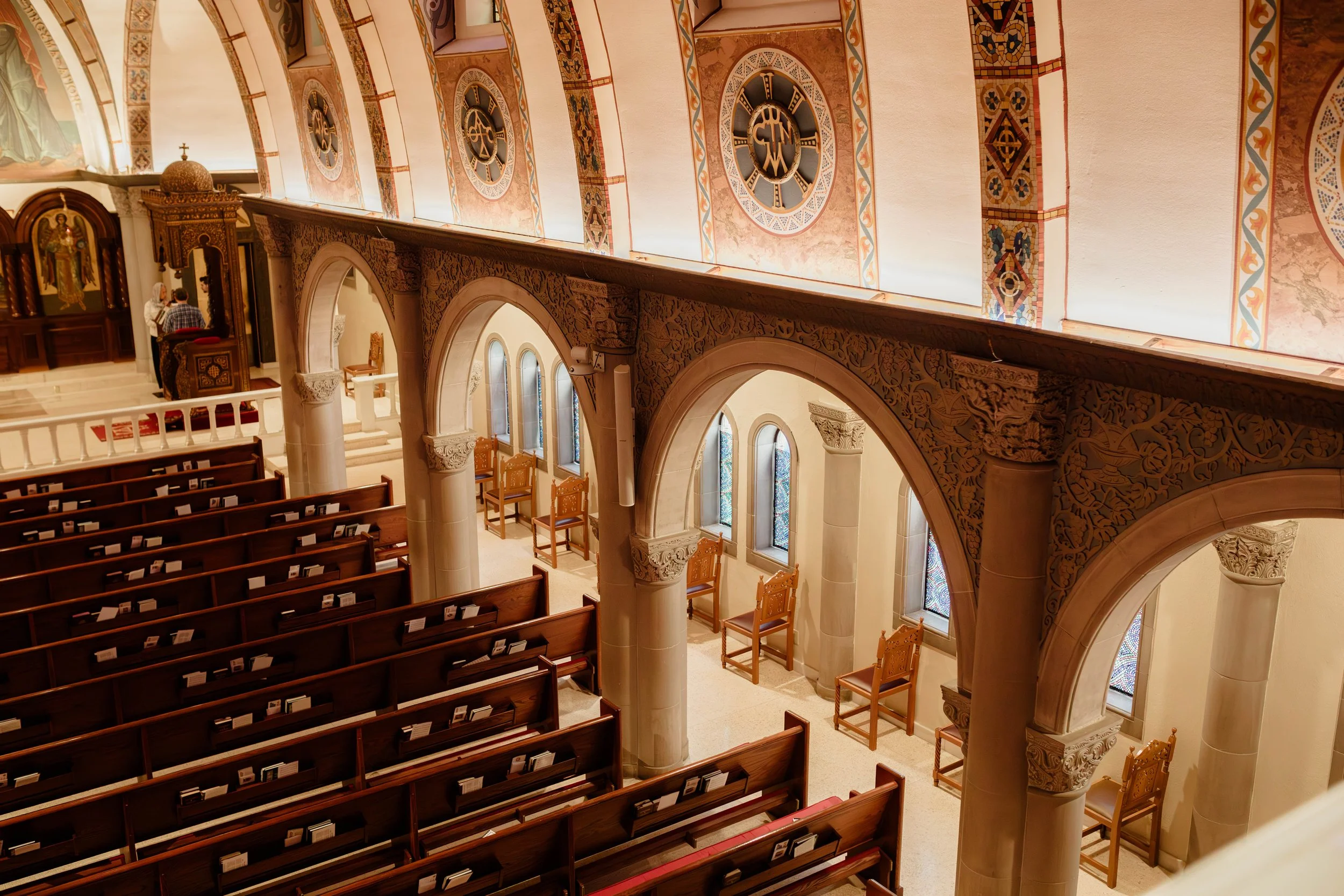 Interior of a Greek Orthodox church featuring Byzantine iconography on the ceiling