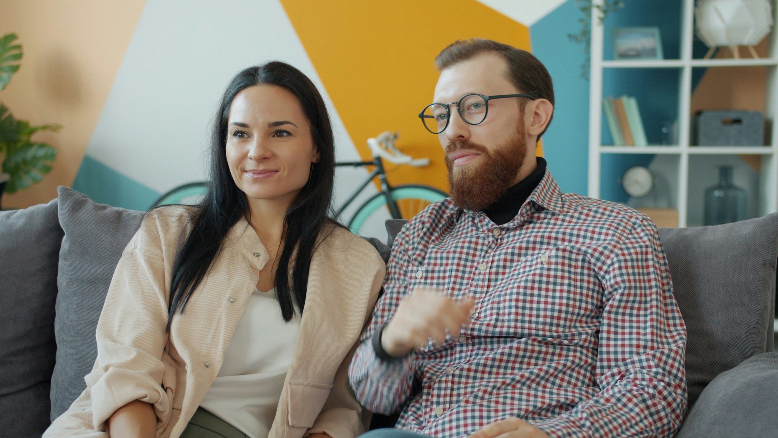 Couple sitting together on a couch during relationship counseling and couples therapy in Houston.
