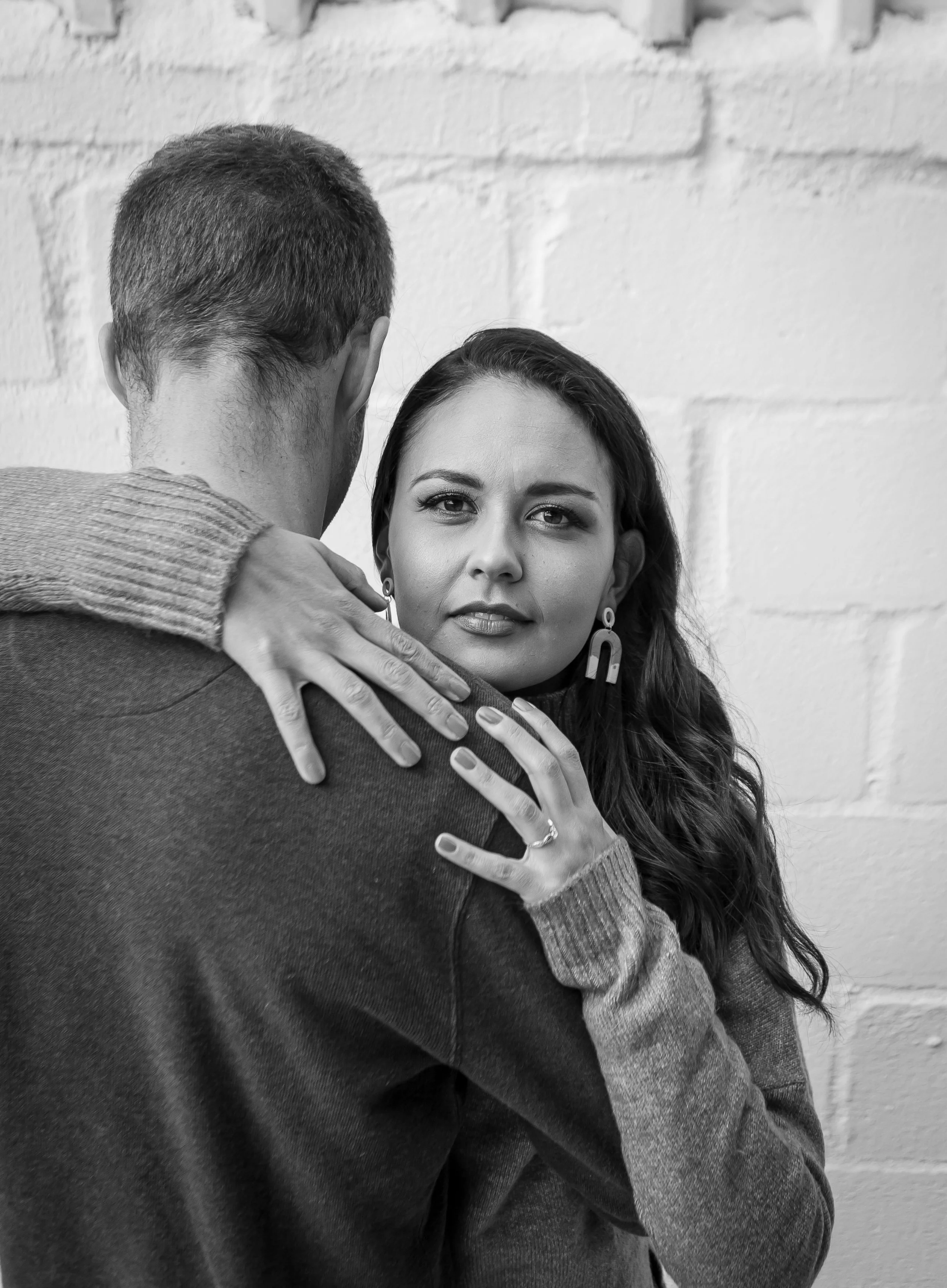 woman holding partner while looking ahead, representing newfound self-trust and resilience through therapy for relationships in Houston.