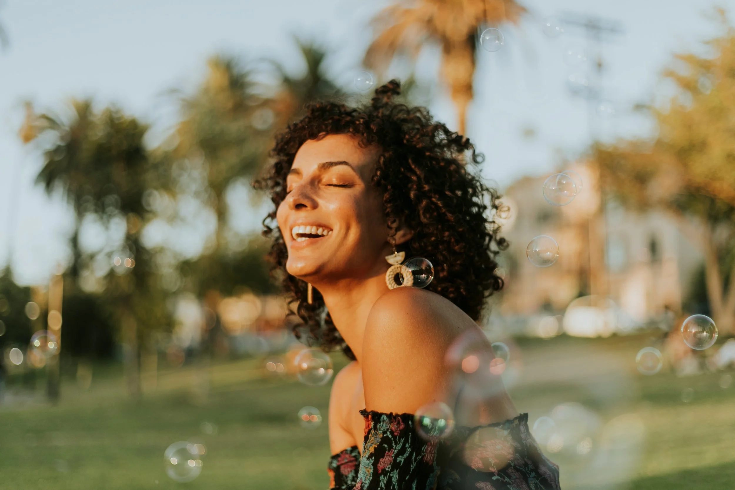 A woman smiles, feeling secure in herself after working through the self-trust guide she found from Heights Couples Therapy.
