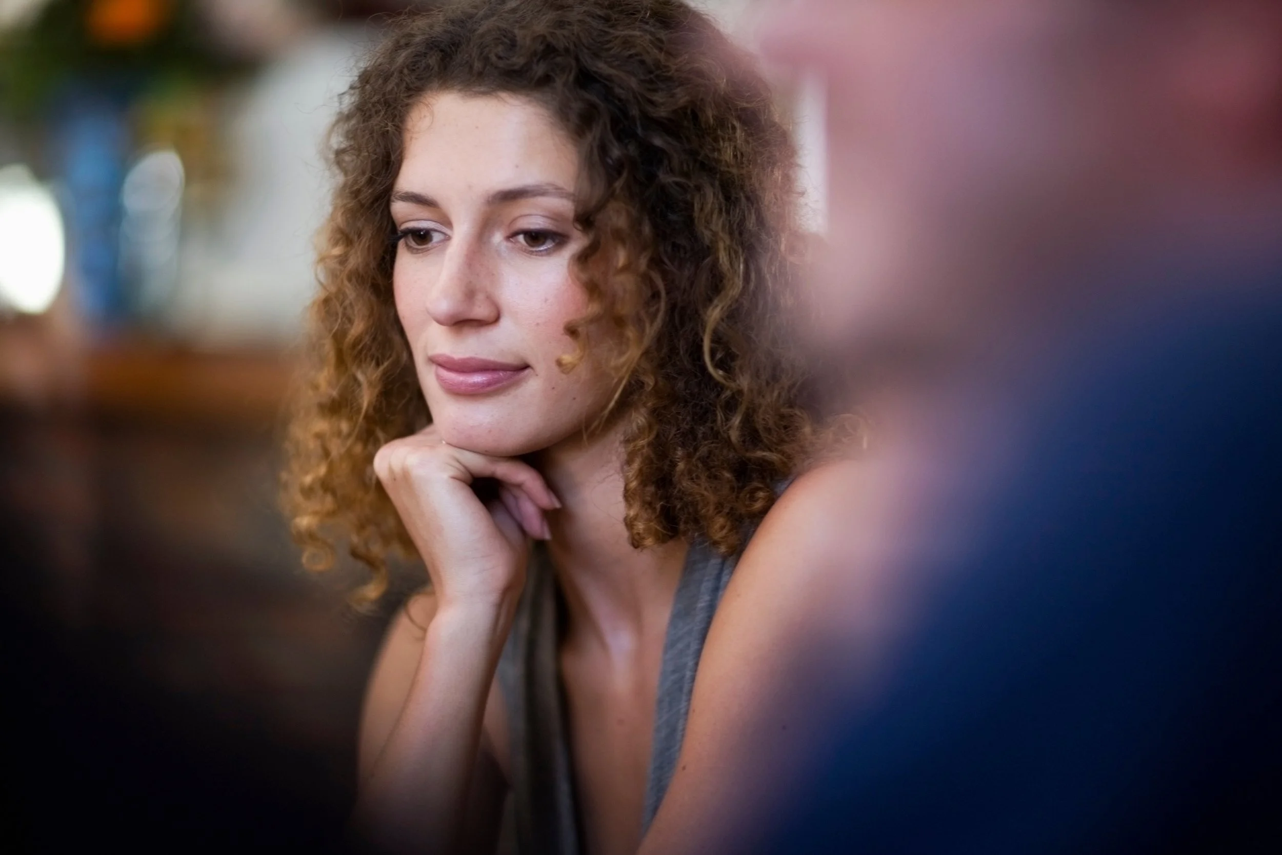 Thoughtful woman reflecting during individual relationship therapy in Houston, exploring personal patterns that impact the relationship.