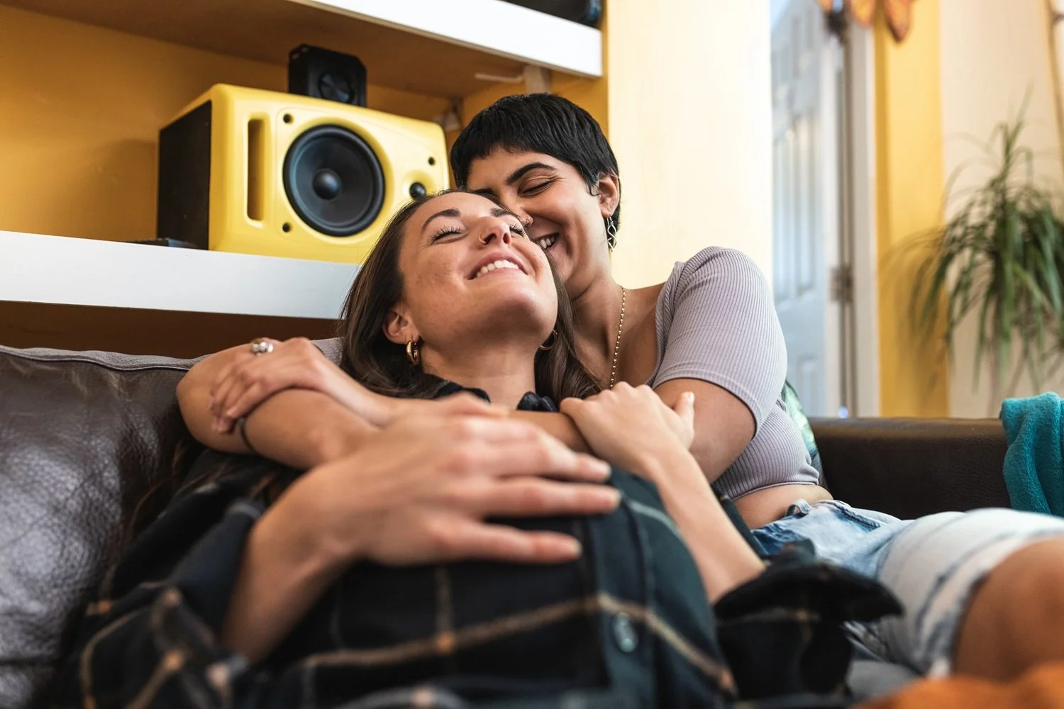 Partners hugging on the couch, reflecting craving closeness and building connection in relationships with Houston couples therapy support.