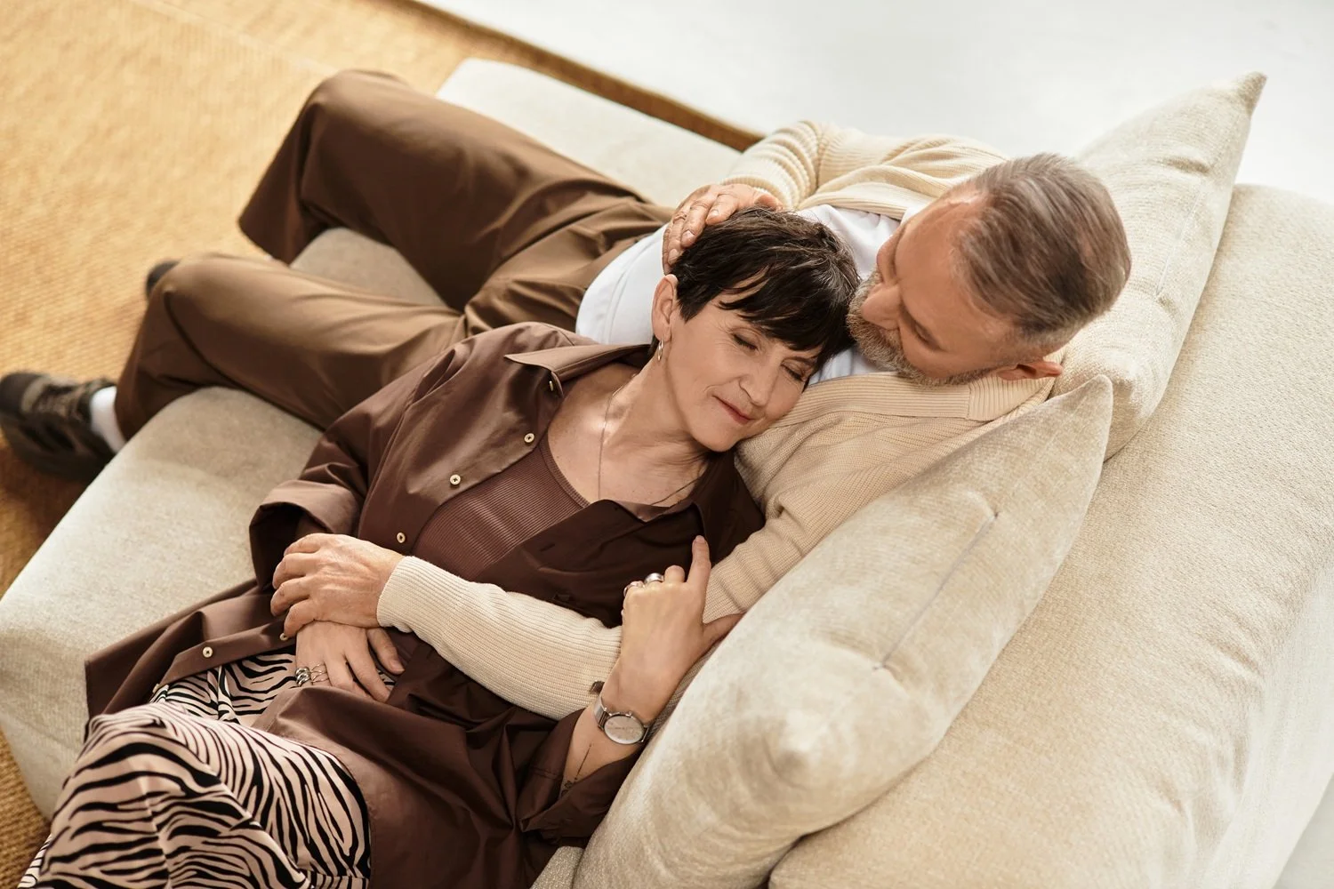 Older couple resting and holding each other, expressing craving closeness and steady connection in relationships nurtured through Houston couples therapy.