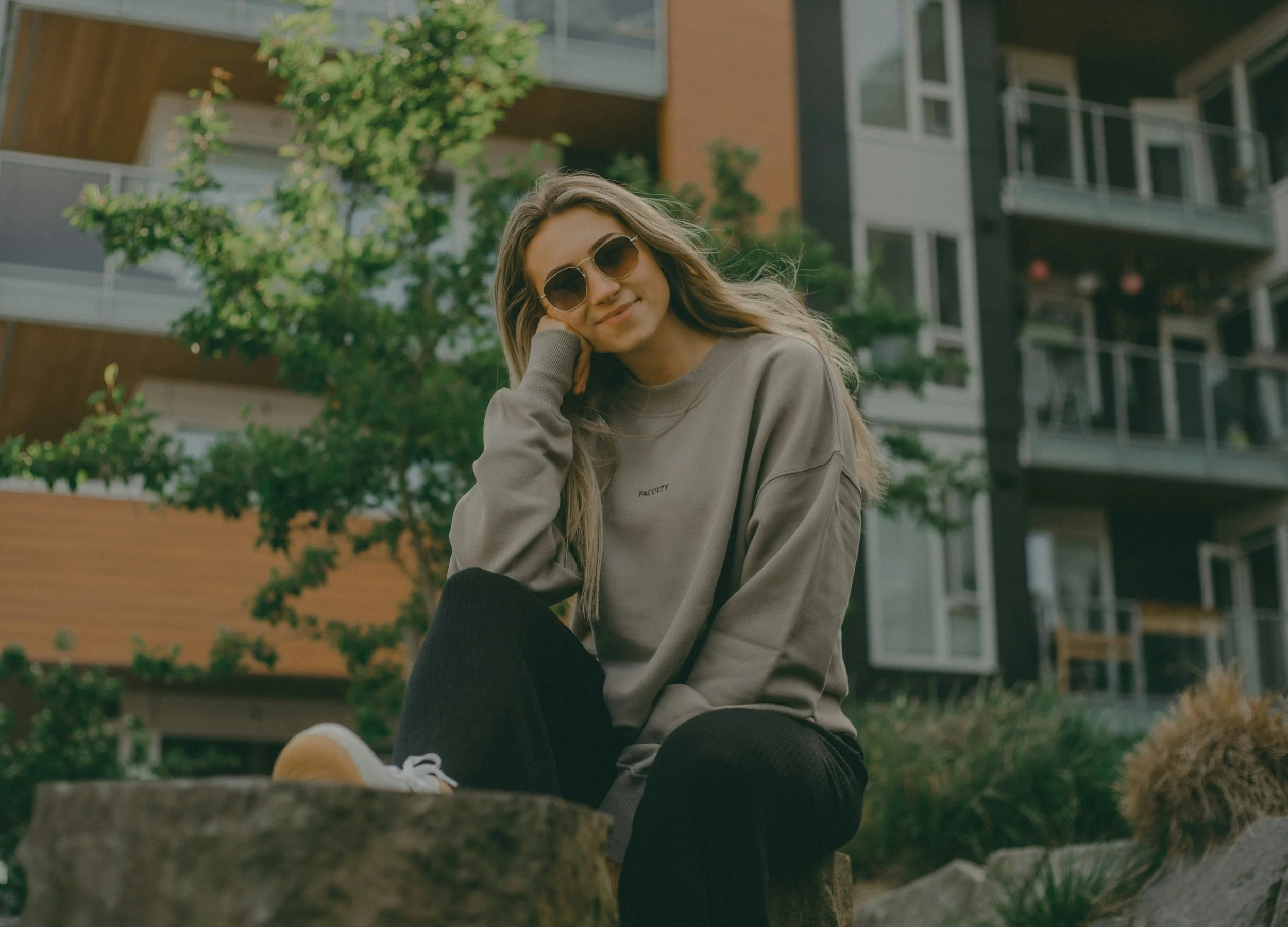 woman sitting outdoors reflecting after a breakup, representing emotional healing and moving forward after a relationship ends