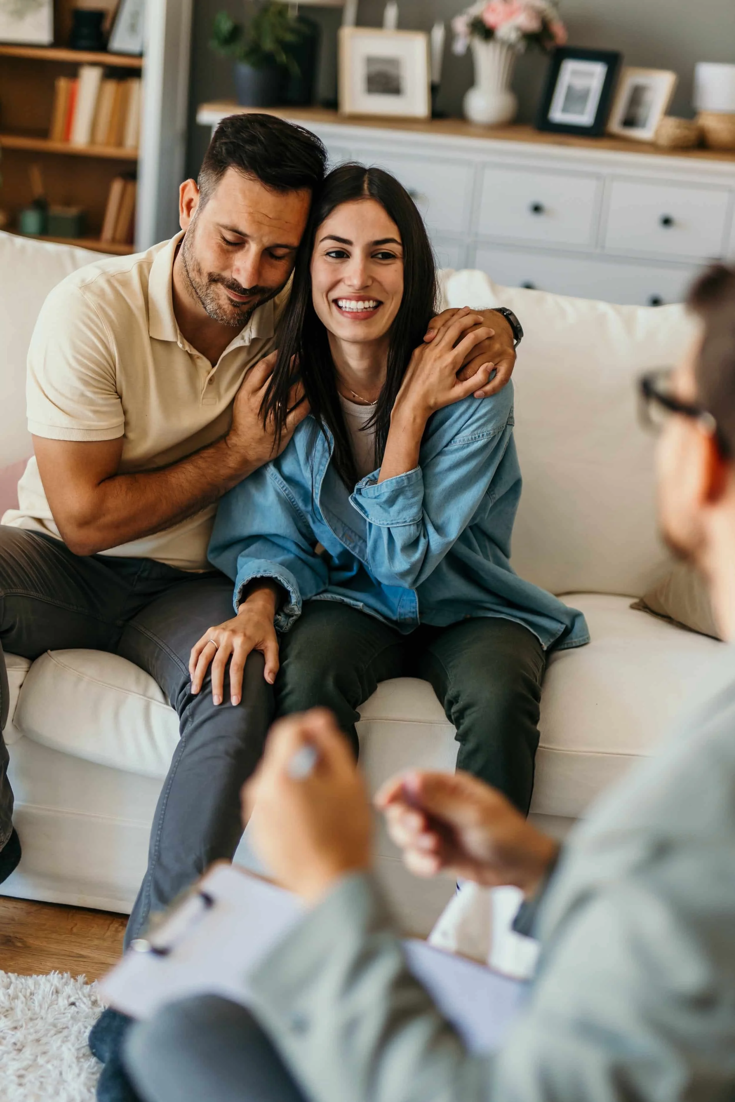 Couple on white couch with a couples therapist in Houston