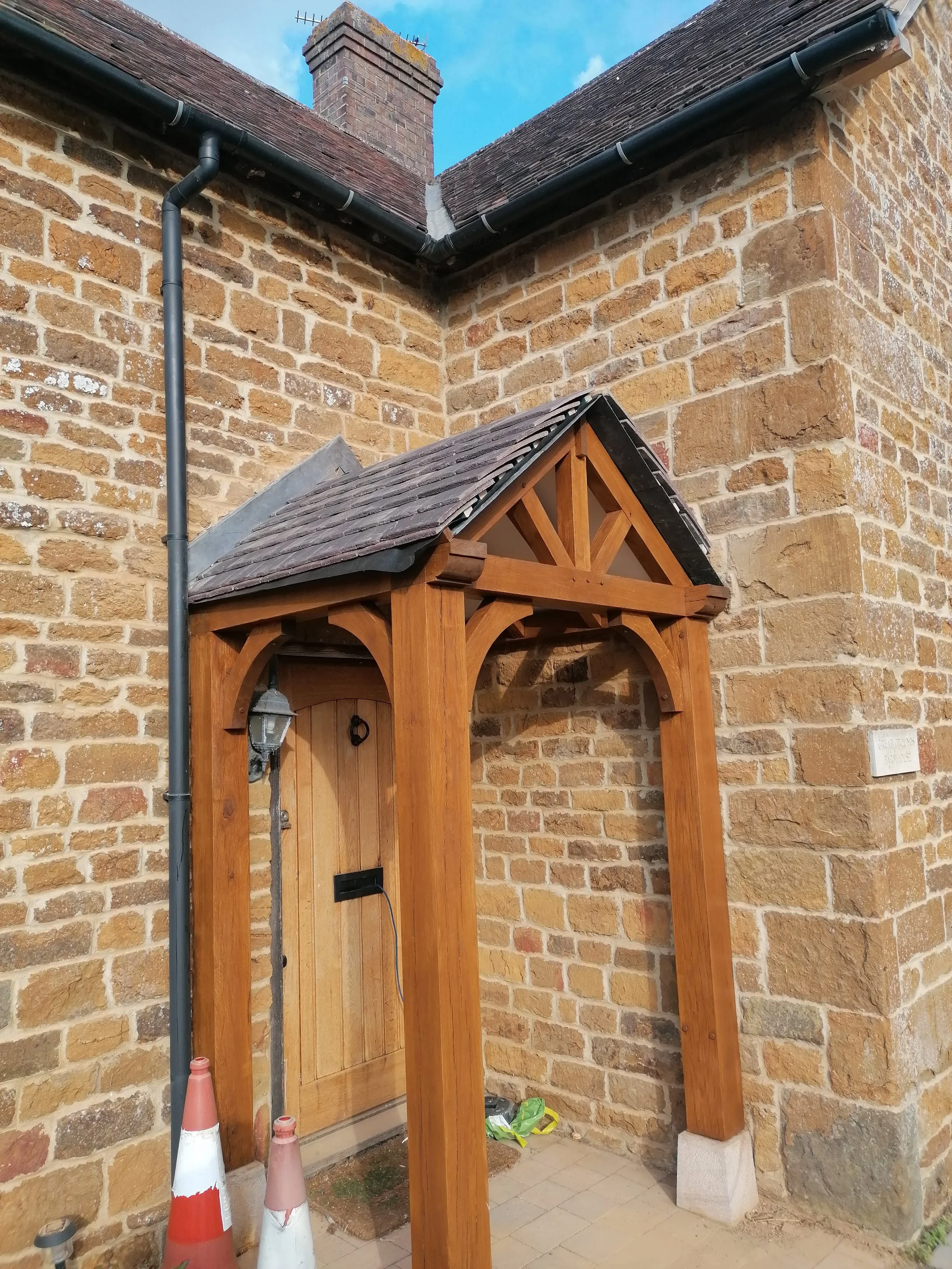 oak porch with tiled roof , stained in light oak
