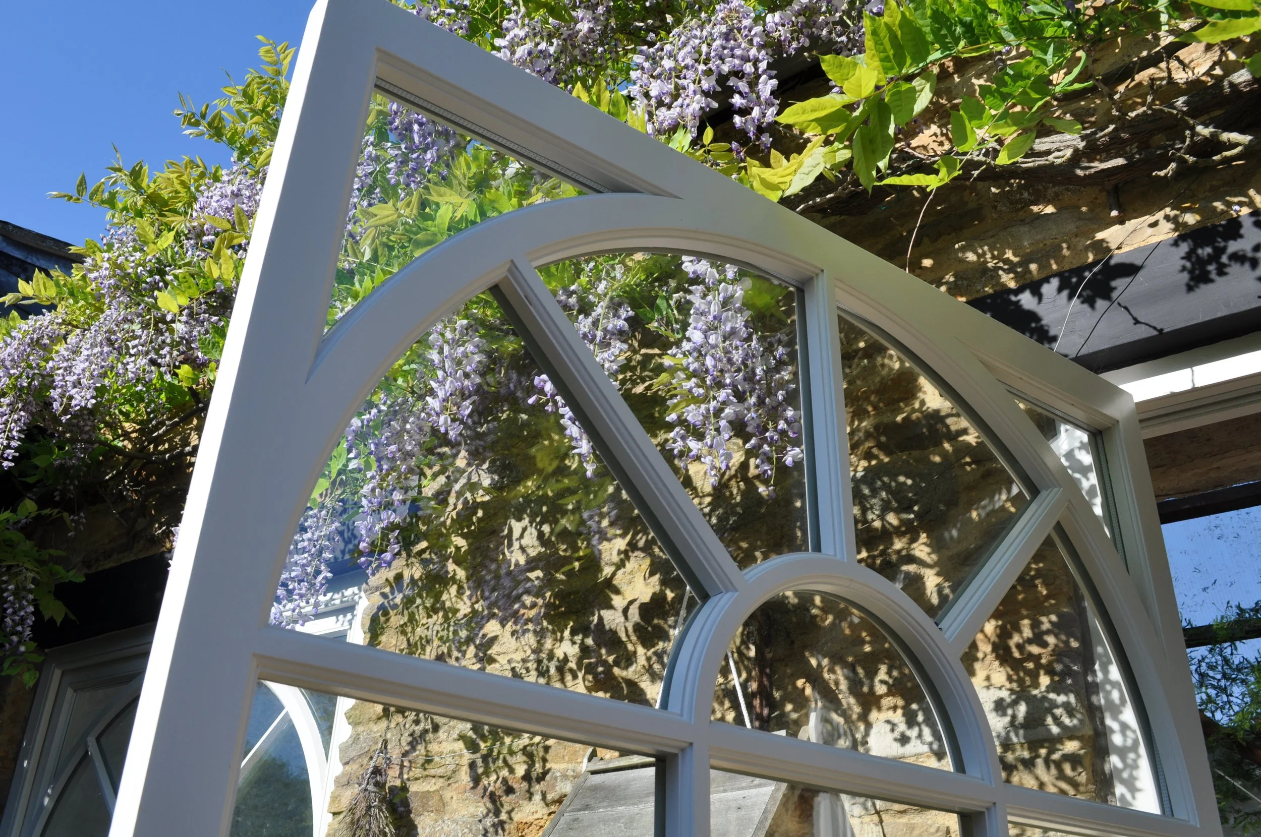 top half of a door with arched bars on it