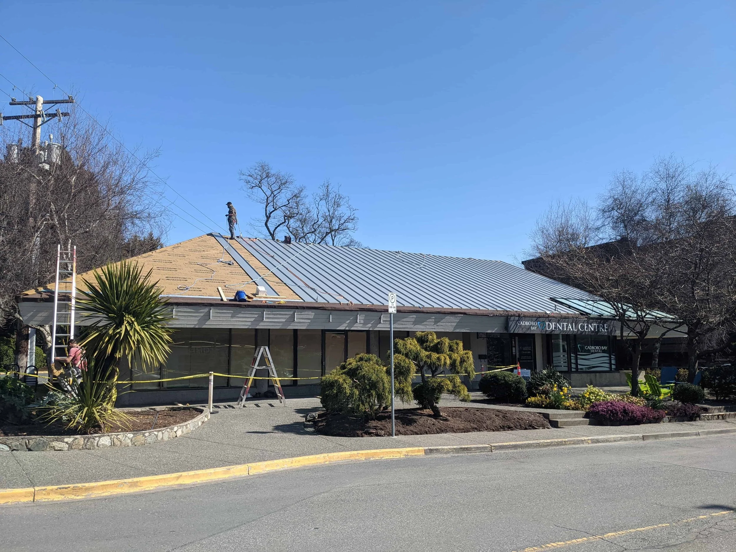 Metal roof being installed on commercial building in Cadboro Bay. 