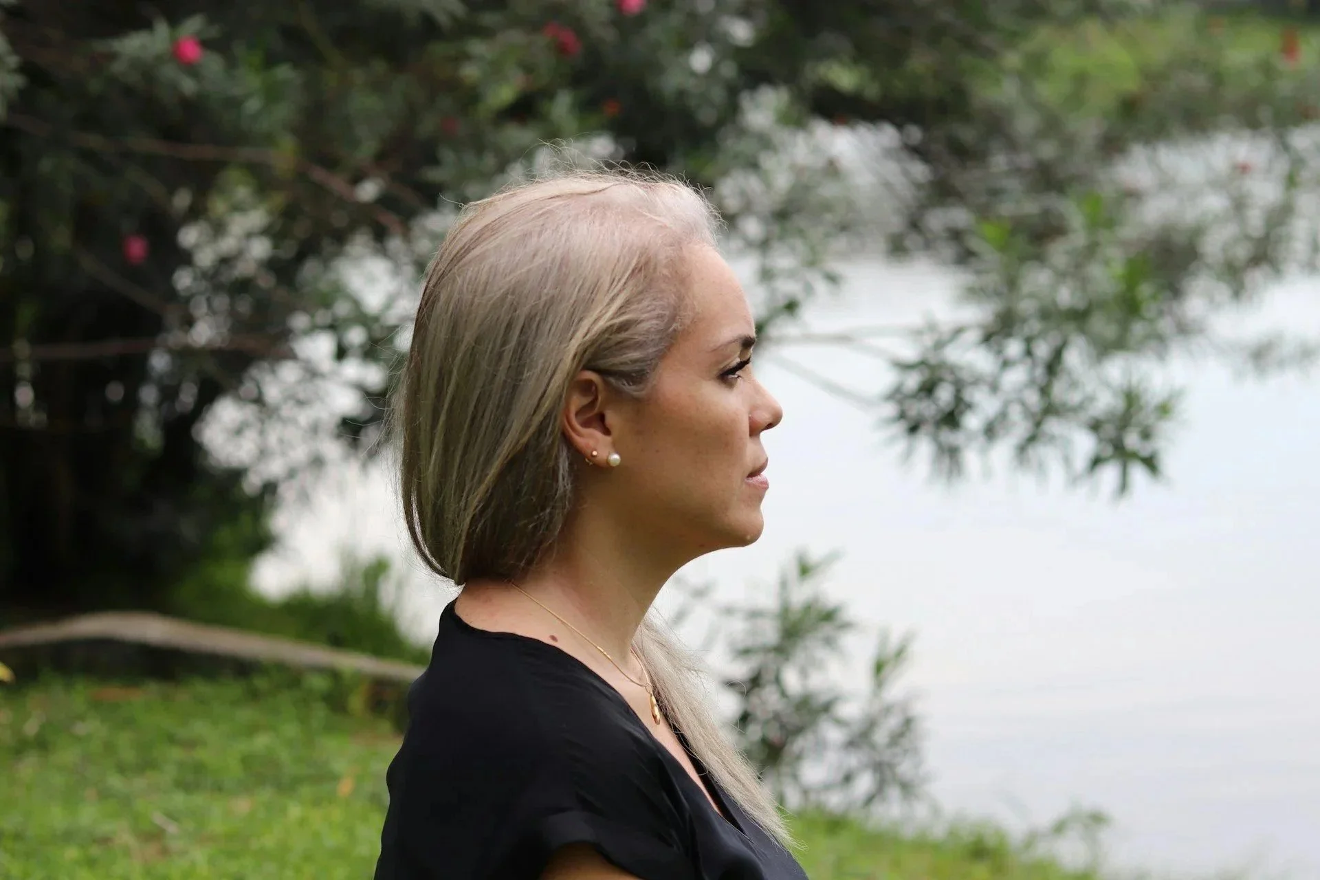 Professional woman in contemplation outdoors considering infidelity counseling and affair recovery options